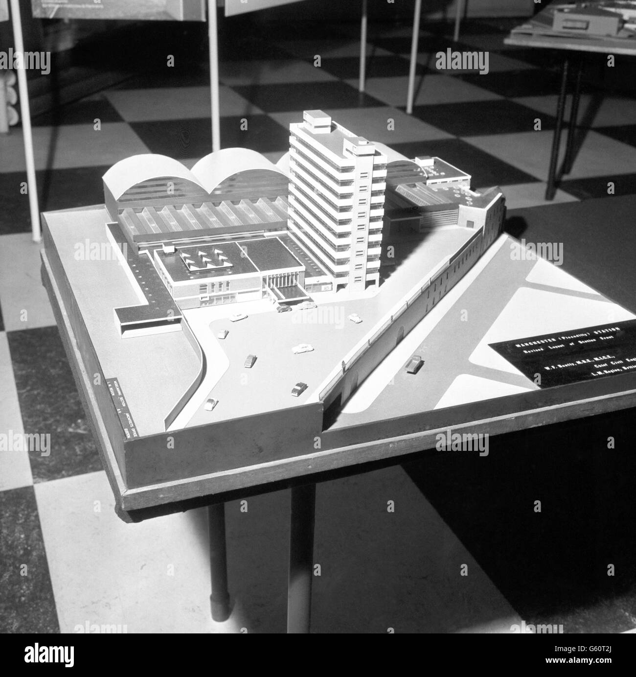 Chairman of the British Railways Board, Dr Richard Beeching, pictured with a model of the modern Piccadilly Station in Manchester. He formally opened the 'New Railway Architecture' exhibition during a preview today at the Building Centre in Store Street, London, where the display - comprising models, photographs and drawings - runs from tomorrow until December 21. Dr Beeching is pointing to the station's tower block of offices, which is occupied by London midland Region of British Railways. Stock Photo
