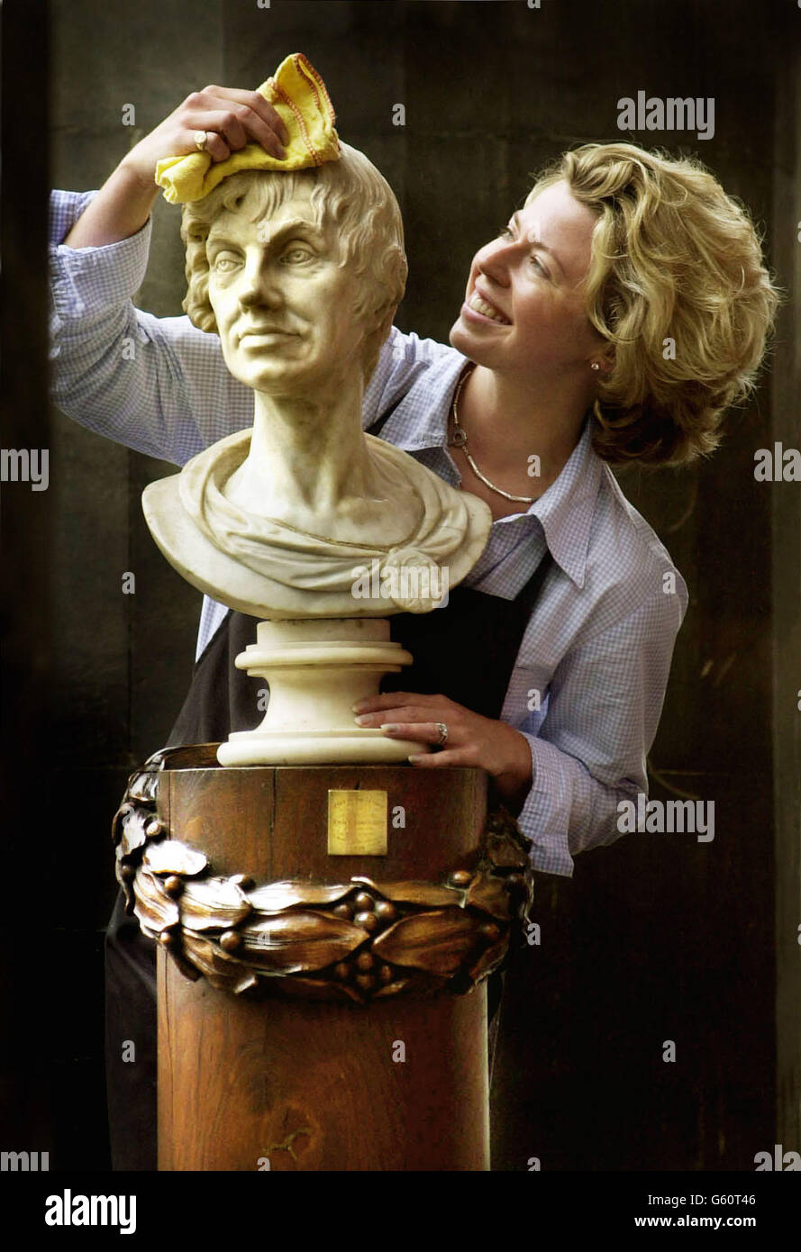 Joanna Frain-Bell from the Scottish auction house Lyon & Turnbull mops Nelson's brow before he goes under the hammer. One of Scotland`s oldest gentlemen's clubs, the Caledonian club, is saying farewell to its oldest member. * a bust of Horatio Nelson by Laurence Gahagan, dated 1806. It stands on an oak plinth with carved laurel wreath, made from the mast of Nelson's HMS Victory. The bust is expected to fetch 12,000 when it goes under the hammer at a Lyon & Turnbull auction in Edinburgh on the 28th September. Stock Photo