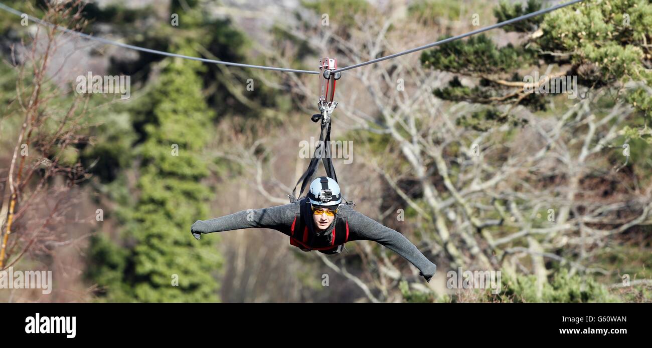 Matt Shaylor, 39, from Cwm Penmachno goes down the zip wire at Zip World in Penrhyn Quarry, Bethesda, Bangor, North Wales. Stock Photo