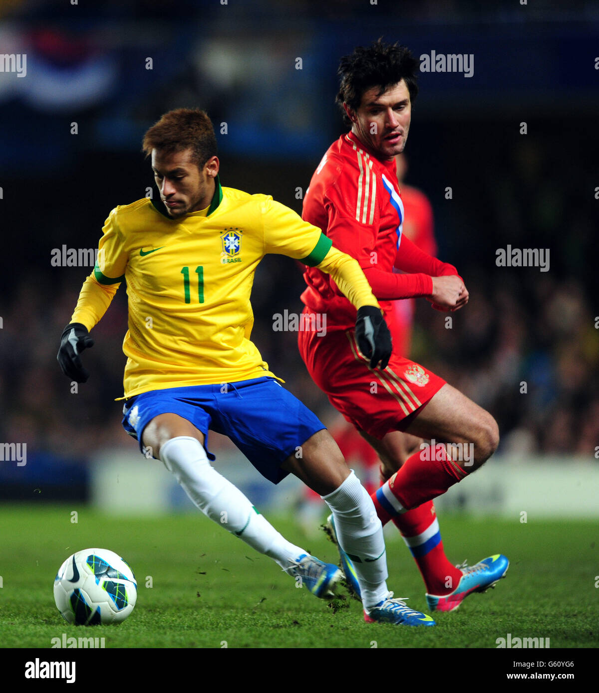 Soccer - International Friendly - Brazil v Russia - Stamford Bridge. Brazil's Neymar and Russia's Yury Zhirkov during the International match at Stamford Bridge, London. Stock Photo