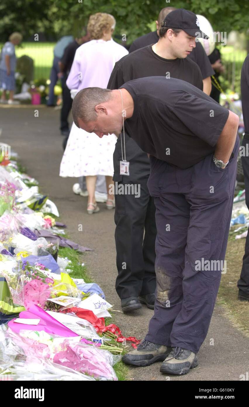 Members of the public look at flowers laid in the grounds of St Andrew's Church in Soham, Cambridgeshire in memory of the murdered schoolgirls Holly Wells and Jessica Chapman. Stock Photo