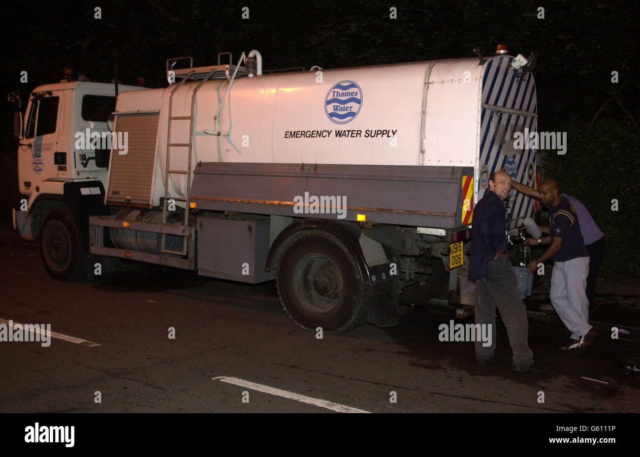 Residents in Streatham, south London, fill containers from an emergency water supply bowser, About 9,000 homes were without water supplies tonight after a mains pipe burst. * Engineers have been battling to restore the water supply after the mains pipe ruptured at about 7am at the junction of Leigham Vale and Palace Road in Streatham. Stock Photo