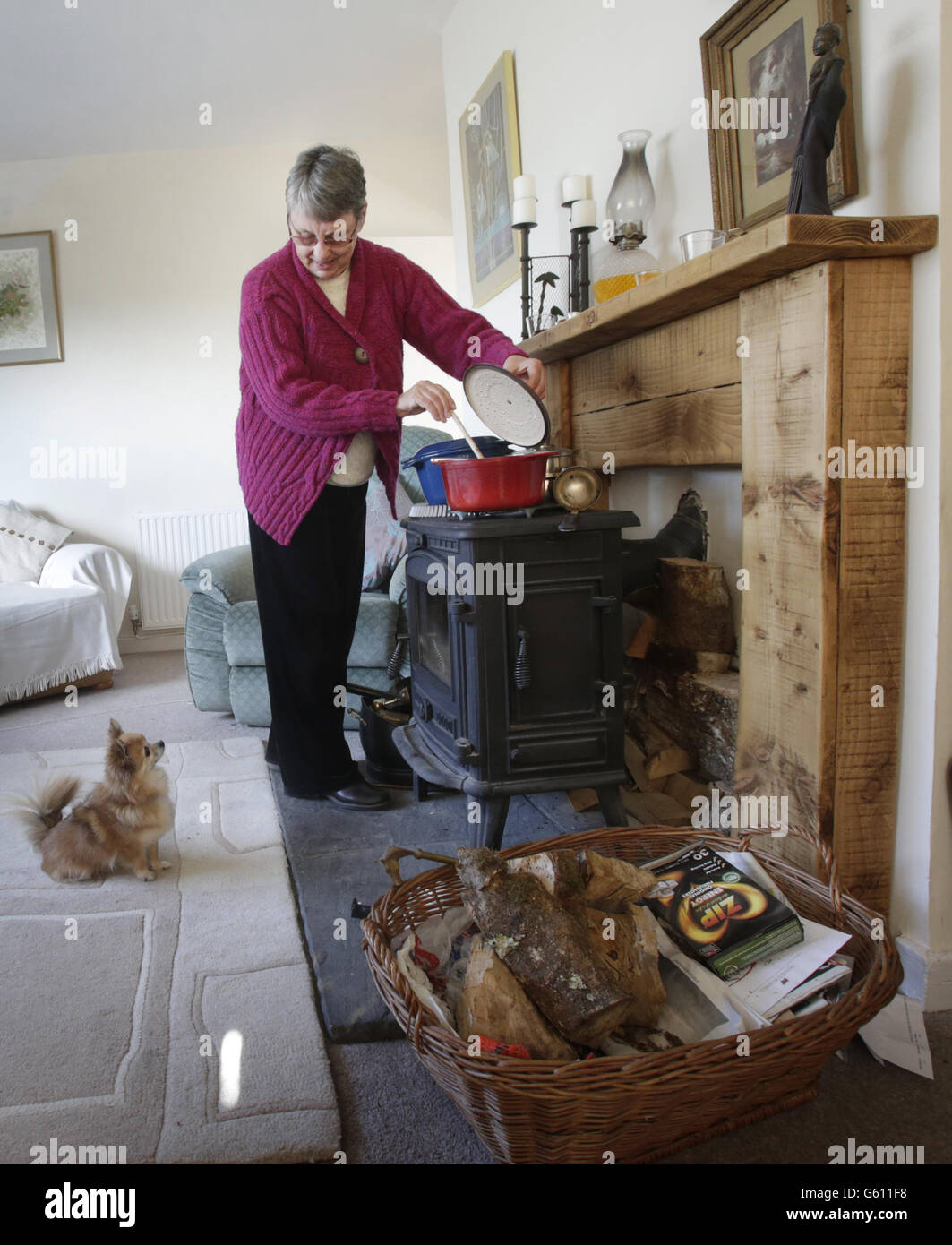 Janette Hamilton cooks on a wood burning stove at her home in Southend in Scotland after loosing her power supply during recent severe weather. Stock Photo