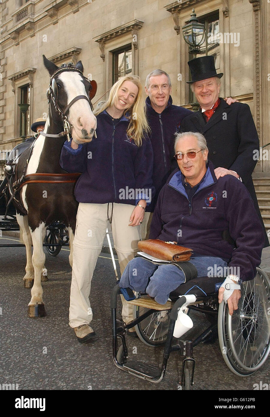 Disabled adventurers Caroline Casey from Dublin who is registered blind, Mike Mackenzie from Oxford who was paralysed and lost his legs in an accident in Bosnia, and Miles Hilton-Barber from Derby who is blind, * with Robin Dunseath adventure leader (dressed as Phileas Fogg) outside the Reform Club in Pall Mall. The group today began a round the world trip based on the journey of ficitional character Phileas Fogg. They will use 80 different modes of transport to complete their expedition. The group left the Reform Club by horse and carriage pulled by horse Arthur. Stock Photo