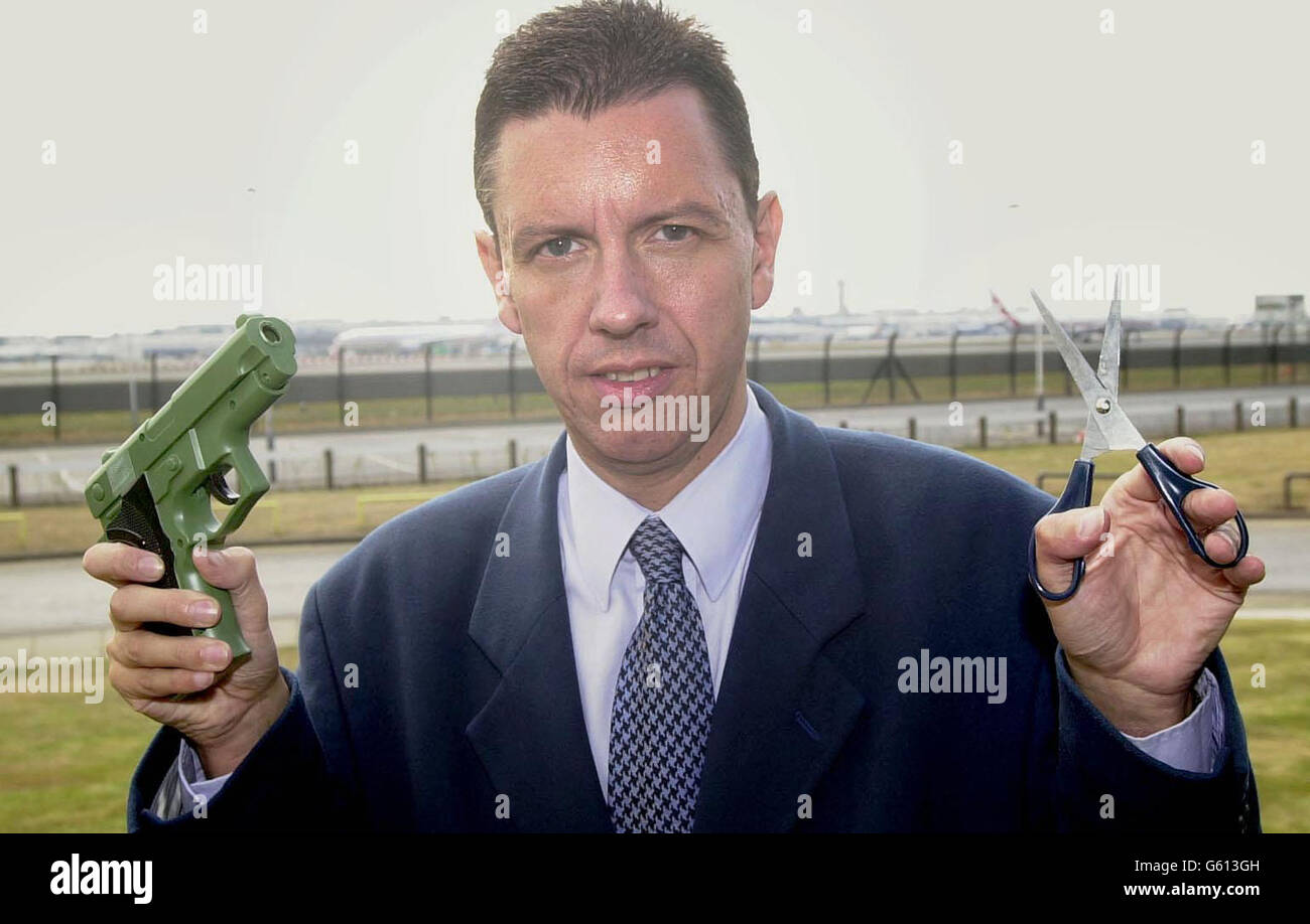 Meridian TV reporter Mike Pearse at Heathrow airport, holding the replica gun and pair of scissors which were smuggled onto internal UK flights. The glaring security lapse has sparked a major investigation. * Mr Pearse took the replica 9mm semi-automatic pistol in a holdall aboard a flight from Heathrow to Edinburgh. Another reporter from the same investigative team carried the six-inch pair of scissors, hidden in a Filofax, on flights from Gatwick and Southampton. Stock Photo