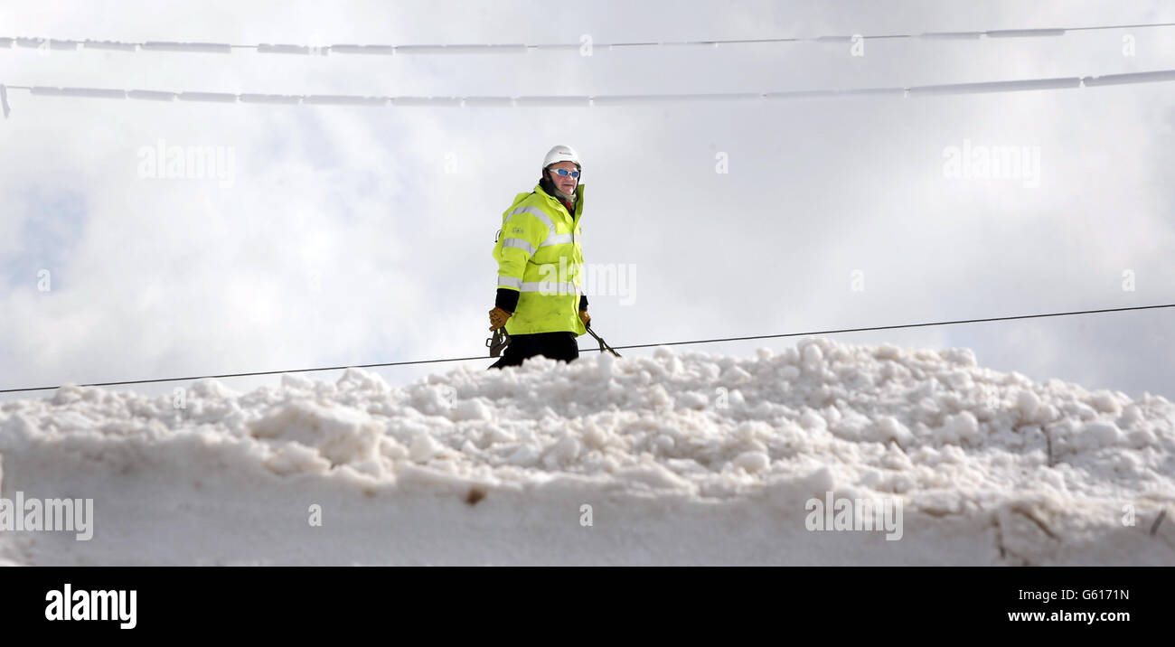 Workers fix a power line in Kintyre in Scotland as communities face a fourth day without power. Stock Photo