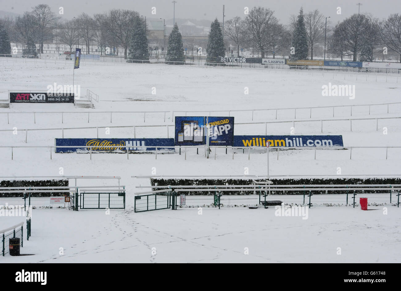 A snowy scene near the winning post as day two of the William Hill Lincoln Meeting at Doncaster Racecourse has been cancelled due to snow. during day two of the William Hill Lincoln Meeting at Doncaster Racecourse. Stock Photo