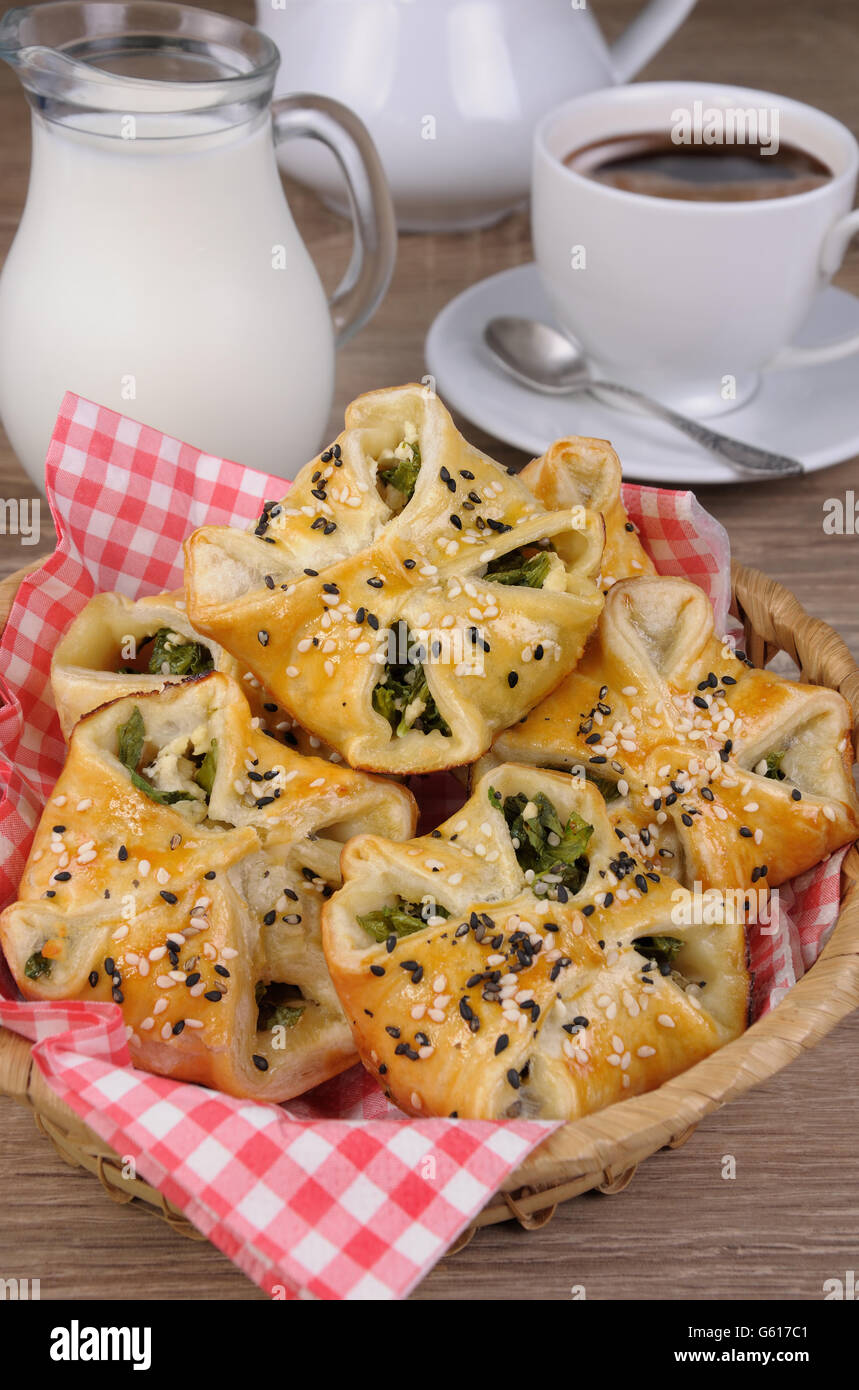 bun  puff pastry with spinach and ricotta in a basket on table Stock Photo