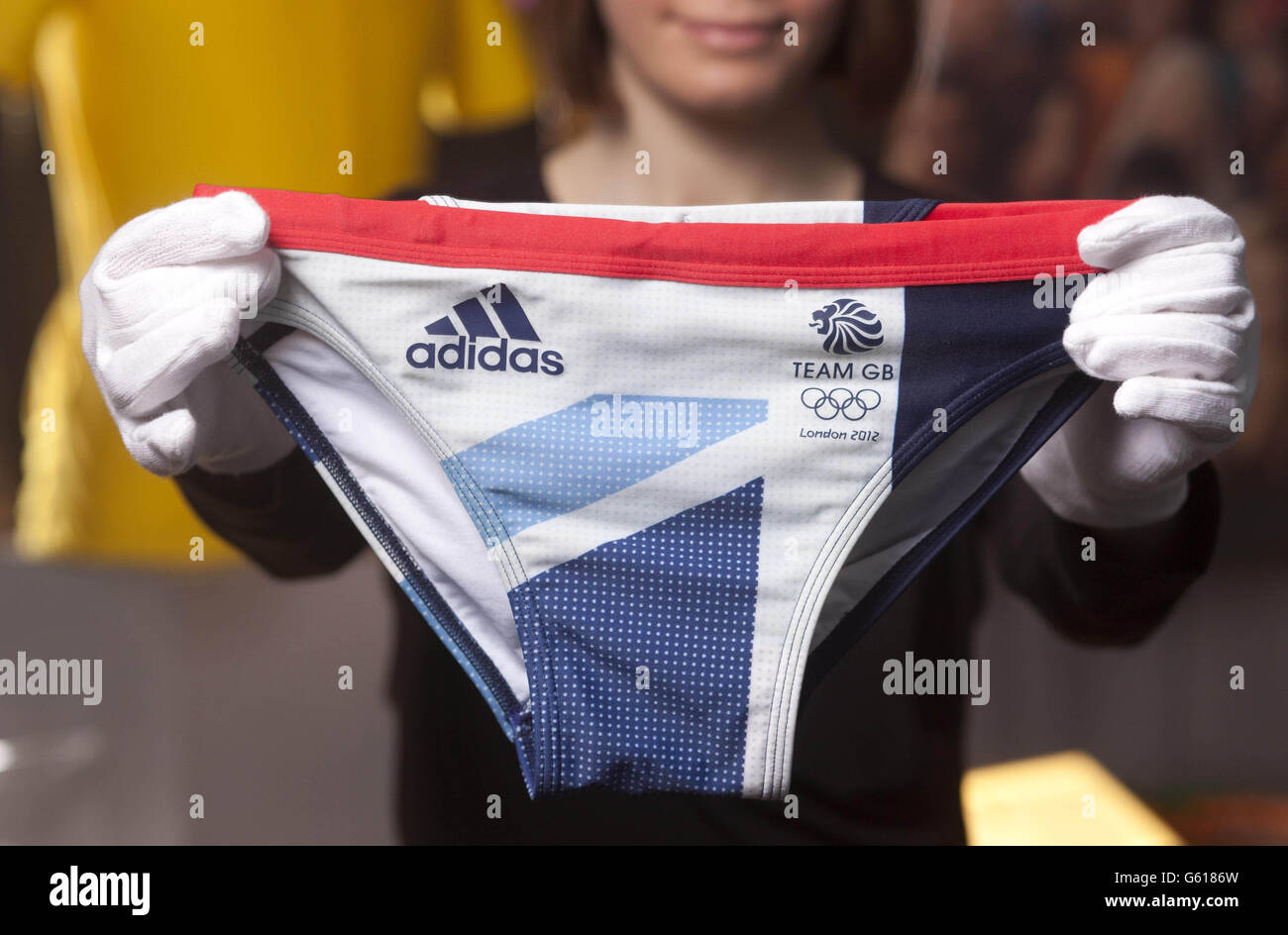 Laura Mitchell of the Museum of London adds the Team GB swimming trunks  worn by Olympic medal winning diver Tom Daley to the new Opening the  Olympics display at the Museum of