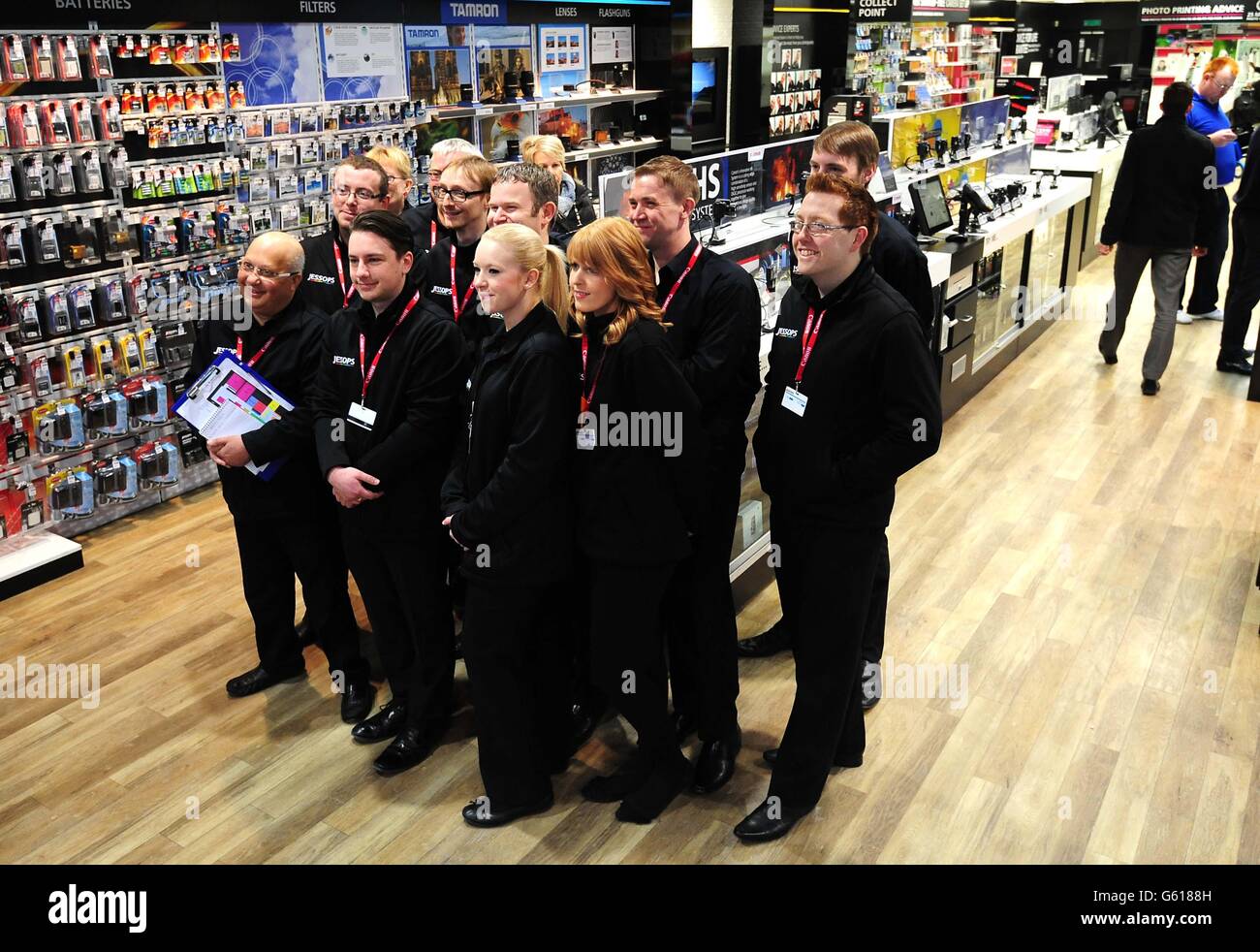 Staff pose for pictures inside the newly opened Jessops store in Birmingham, as Dragons' Den star Peter Jones has relaunched camera chain, two months after it was forced from the high street. Stock Photo