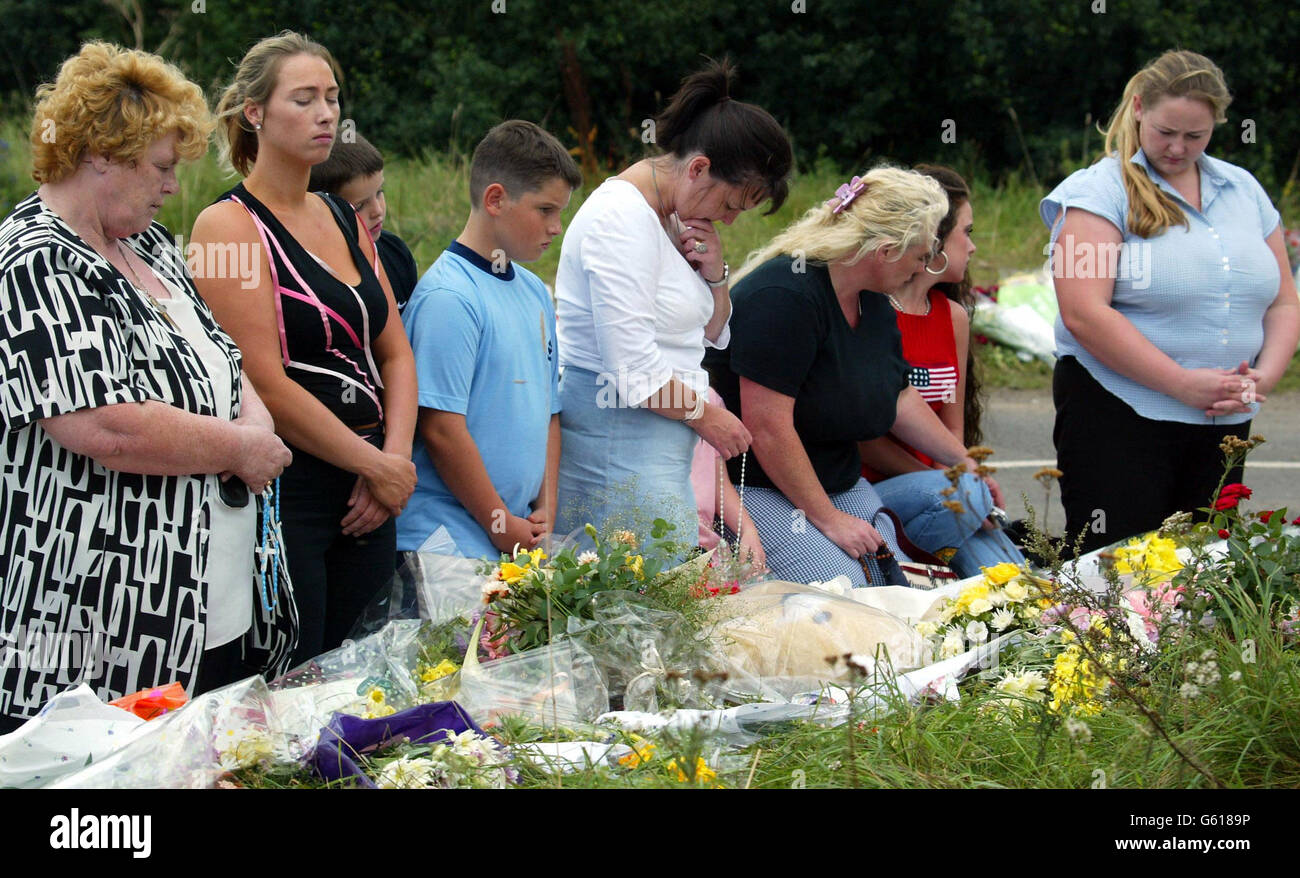 Memebers of the public pray at the one minute silence at the road block near Raf Lakenheath, Suffolk near to the scene where Holly Wells and Jessica Chapman bodies were found on Saturday 17th August 2002 Stock Photo