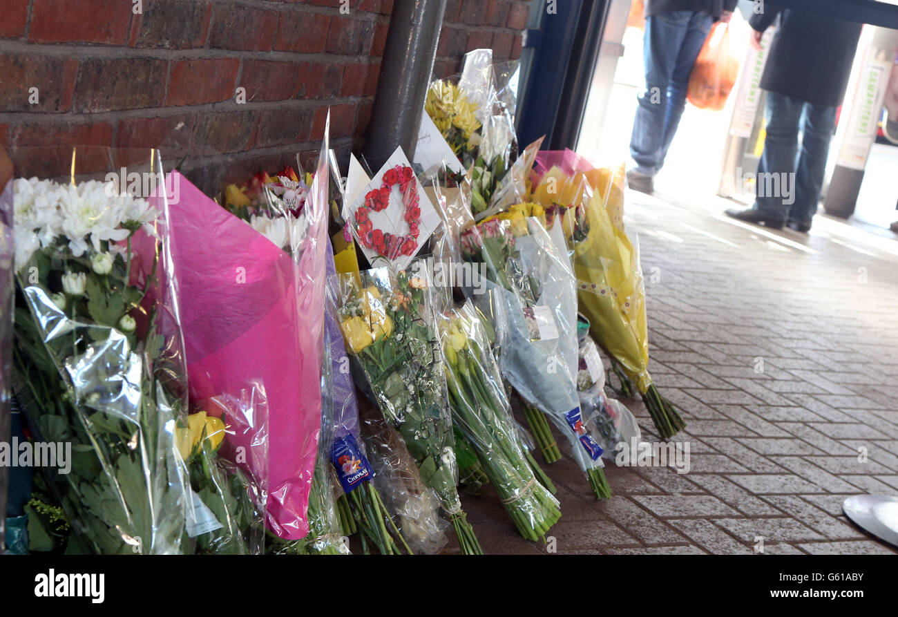 Flowers are left at the railway station in Guildford, Surrey where 22-year-old Ryan Harrison died after being hit by a train following an altercation with a number of other men. Stock Photo