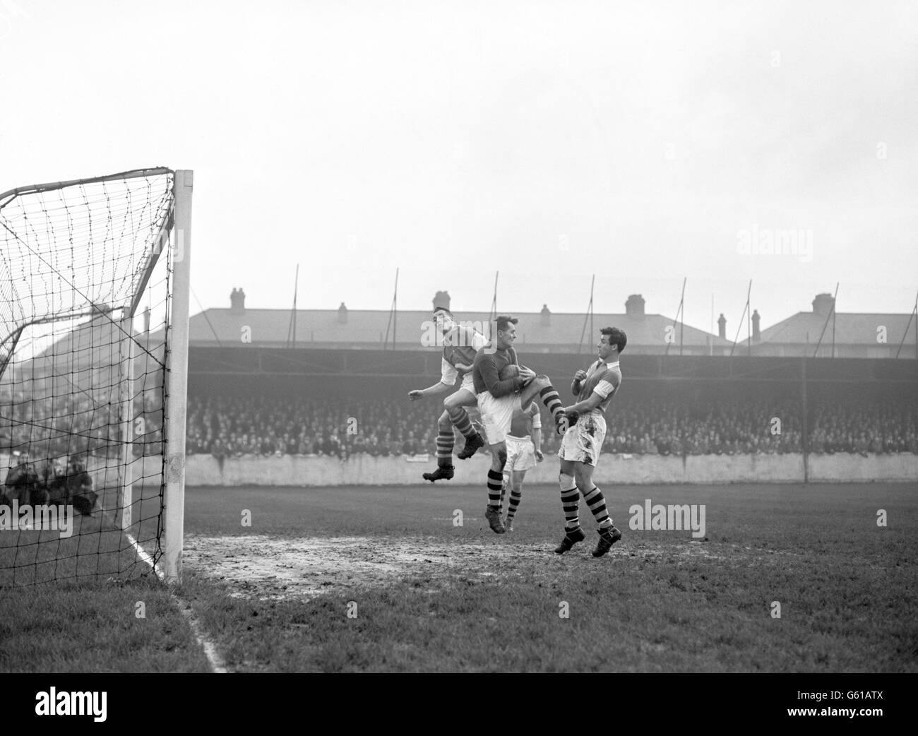 Walthamstow Avenue goalkeeper Stanislaus Gerula gathers the ball under pressure from Ipswich Town's Tom Garneys (l) and teammate Lou Branan (r). Stock Photo