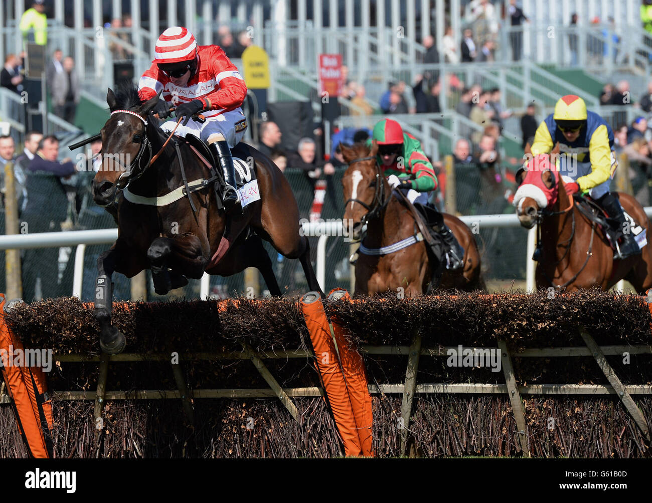 L'Unique and Wayne Hutchinson jump the final hurdle on their way to victory in the Matalan Anniversary Hurdle Rcae during Grand Opening Day of the 2013 John Smith's Grand National Meeting at Aintree Racecourse, Sefton. Stock Photo