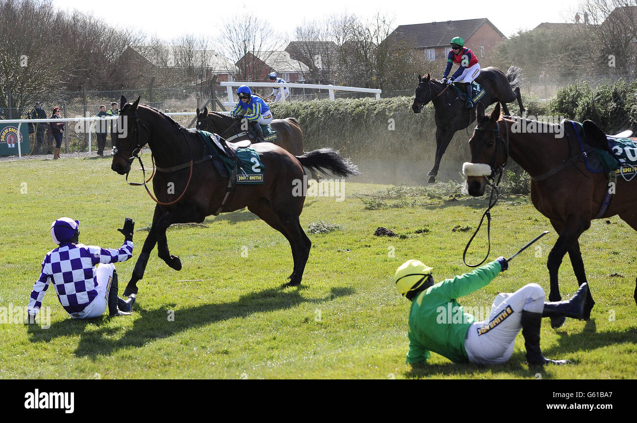 Bold Addition and Mr Steven Clements (left) and Silverburn and Mr J. Tudor fall at Bechers Brook in the John Smiths Foxhunters Chase during Grand Opening Day of the 2013 John Smith's Grand National Meeting at Aintree Racecourse, Sefton. Stock Photo