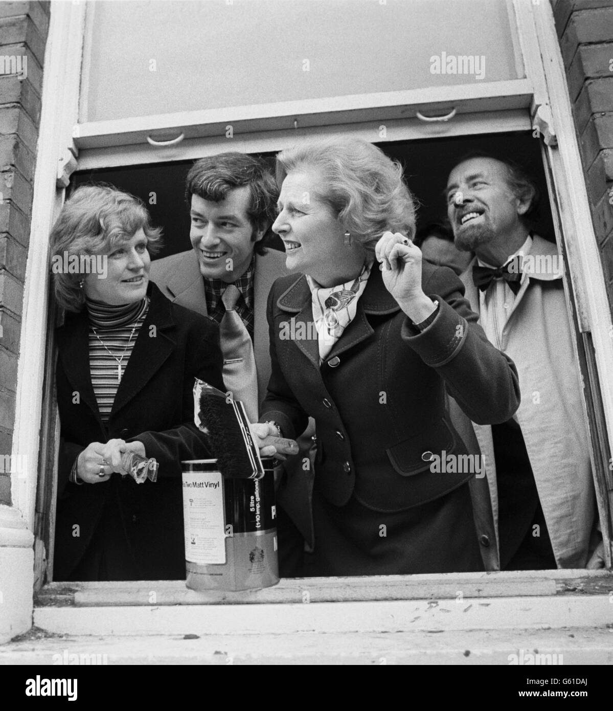 Margaret Thatcher presents brushes and paint to Britain's first homesteaders. The homesteading scheme enables people to buy an old dilapidated property and in return for renovation, they pay no mortgage for three years. Stock Photo