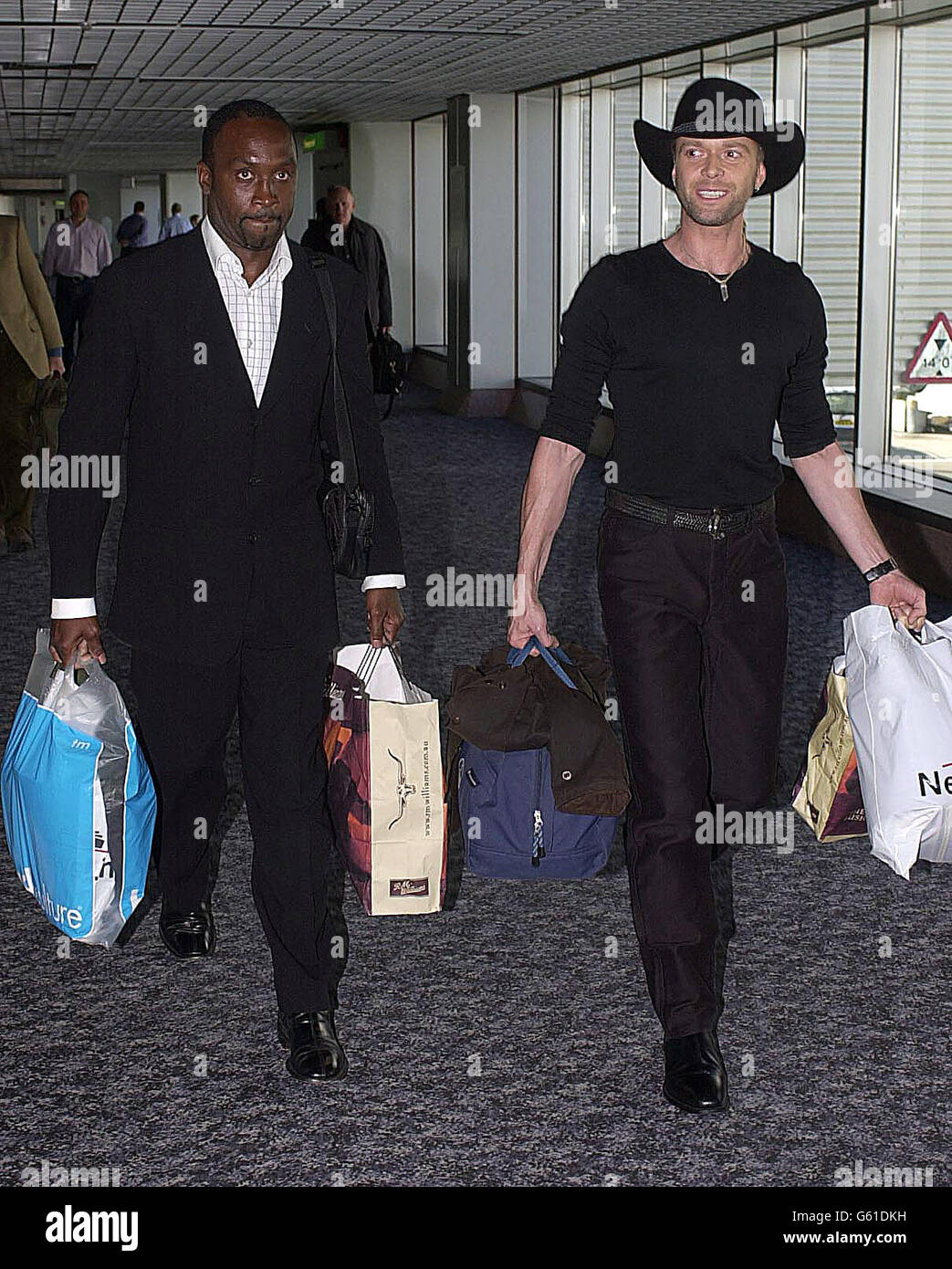 Former boxer Nigel Benn and actor Darren Day arrive at Heathrow Airport, London, after appearing in 'Im A Celebrity Get Me Out Of Here'. Stock Photo