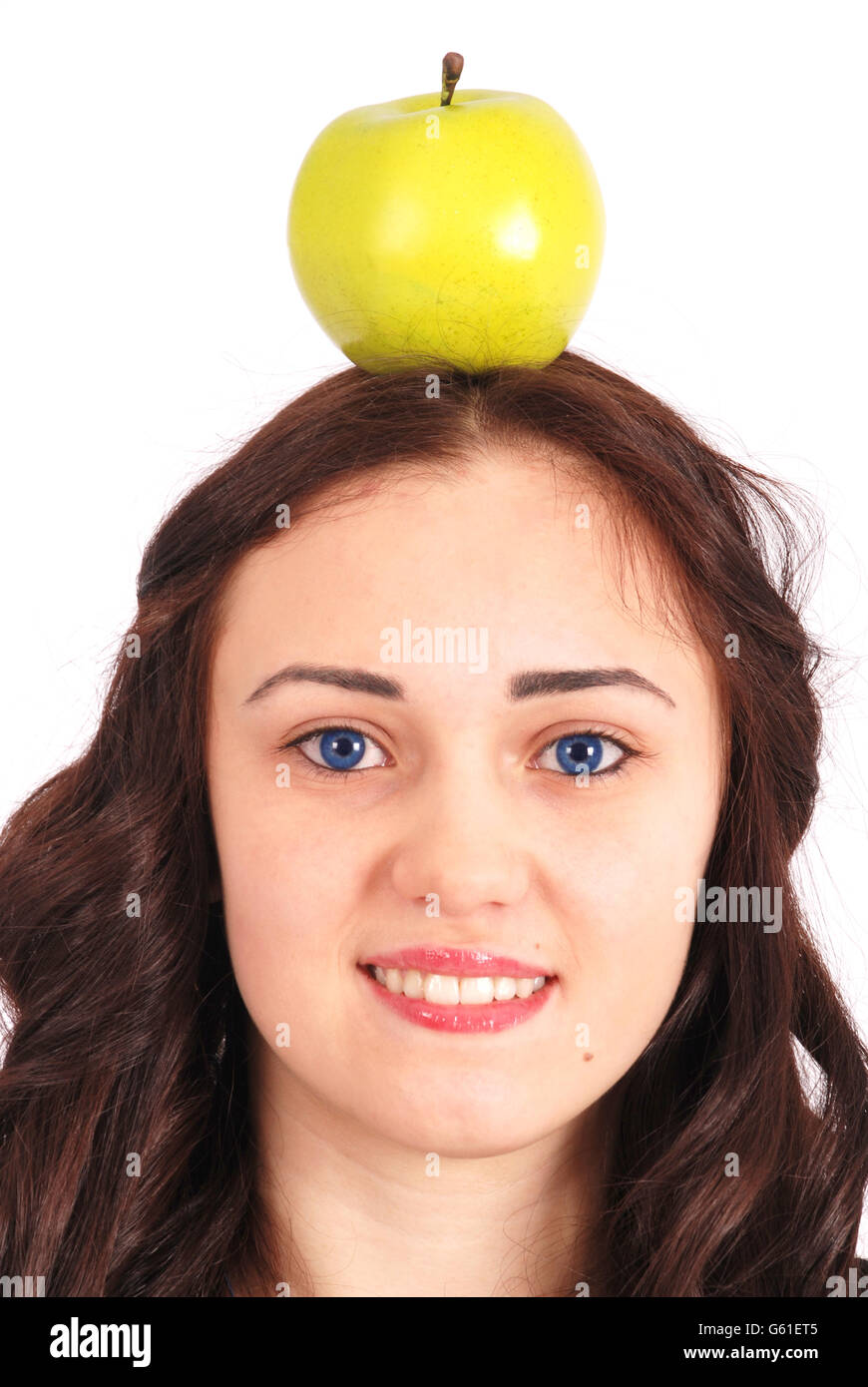 Girlteenager keeps on head green apple isolated on white Stock Photo
