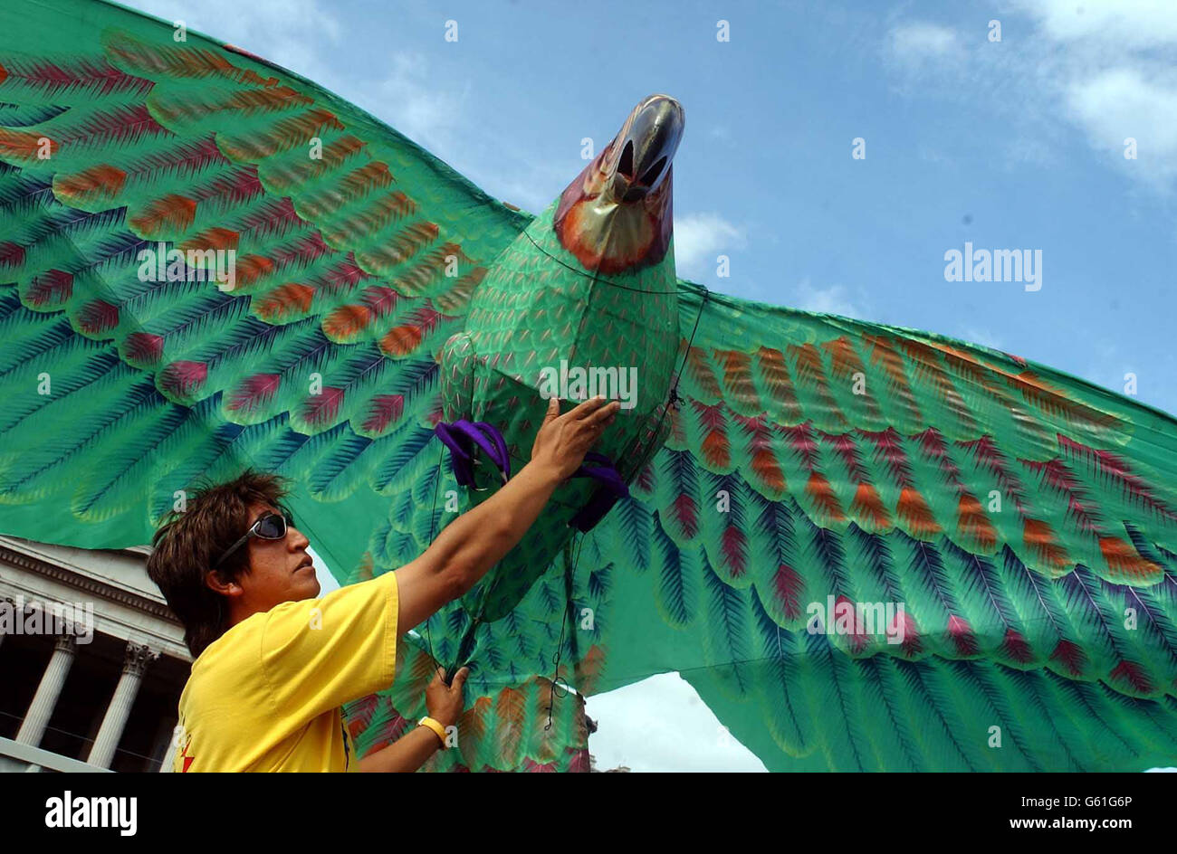 Afghan kite flying festival in Trafalgar Square, London, performed by artist Nasser Volant, as part of the London Mayor's Summer in the Square events programme. Nasser holds one of his sculptured kites Stock Photo