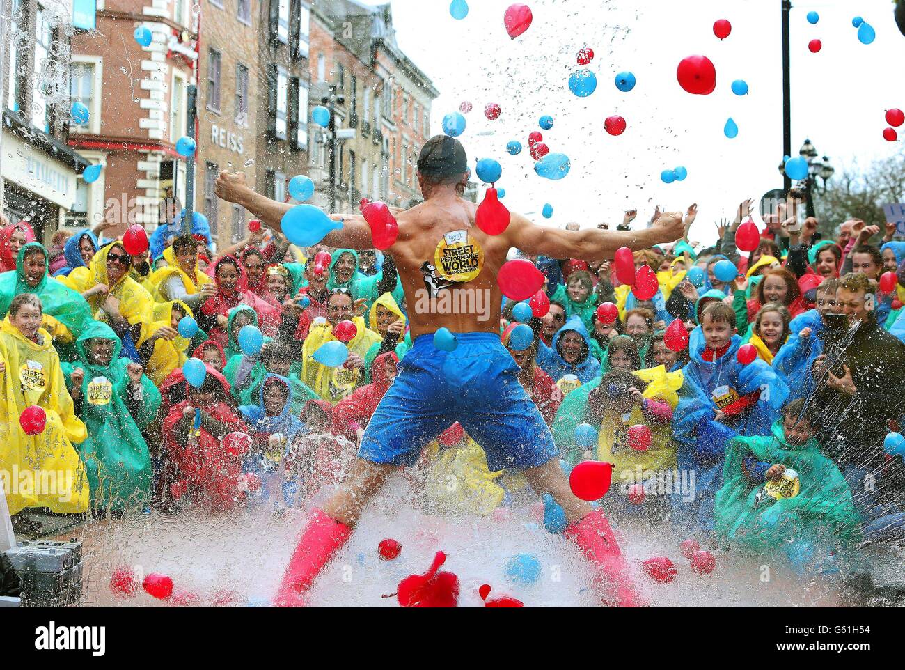 Partygoers throw water balloons at the Minister for Silly Ideas aka comedian Jack Wise in central Dublin, during a photocall for part of the Ministry for Silly Ideas, at the launch the Laya Healthcare Street Performance World Championship . Stock Photo