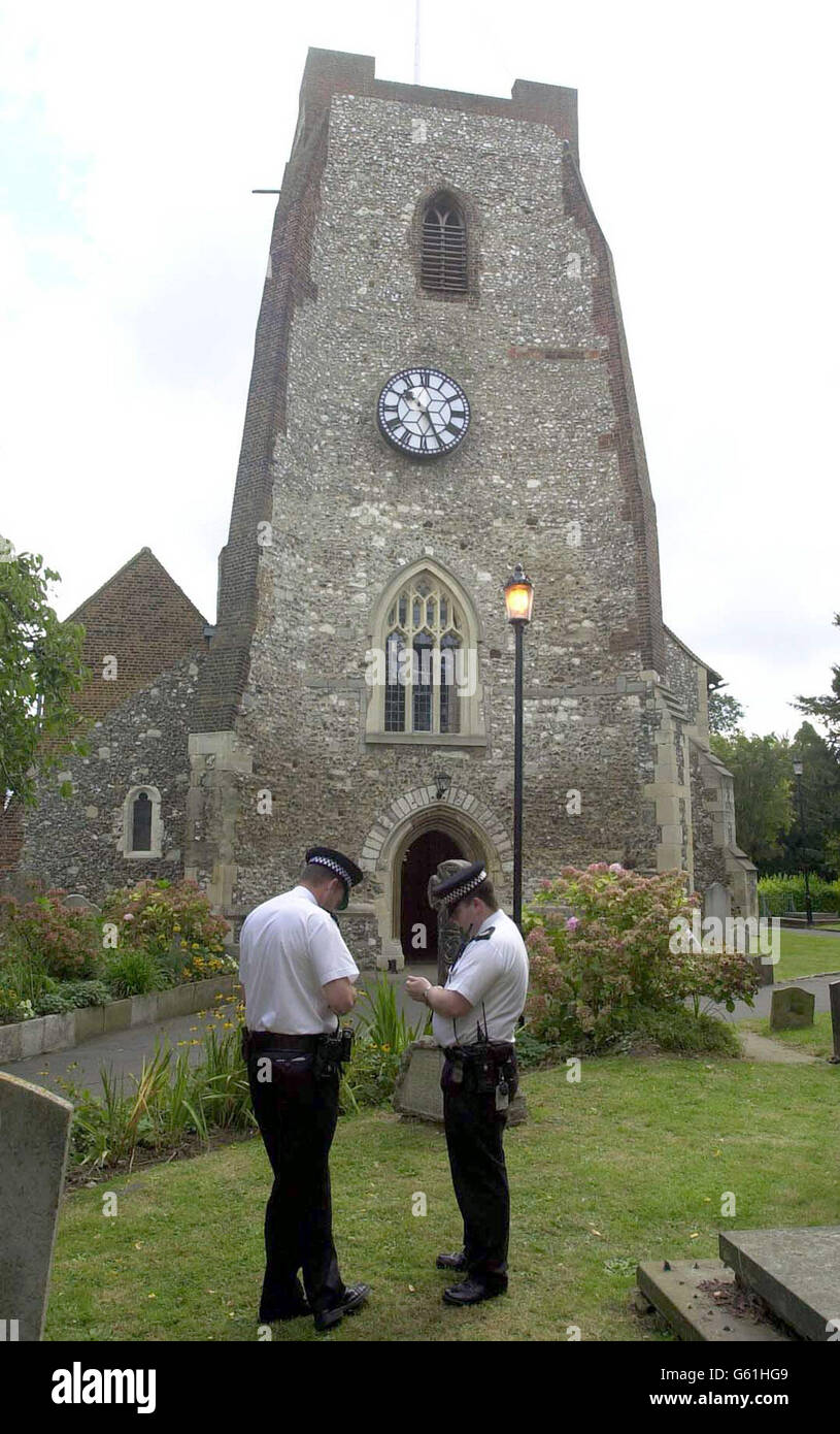 Police officers outside St Mary's Church in Walton-on-Thames where a service for murdered schoolgirl Milly Dowler is being held. *Members of the close-knit Surrey community, grief-stricken by the news that remains found in remote woodland are almost certainly those of the youngster, are being invited to the 12th century Norman church for a service aimed at helping the locals overcome the loss. A candle, lit six months ago when Milly first vanished as an act of hope, will now be relit in her memory and placed at the front of the church for townsfolk to come and quietly pay their respects. Stock Photo