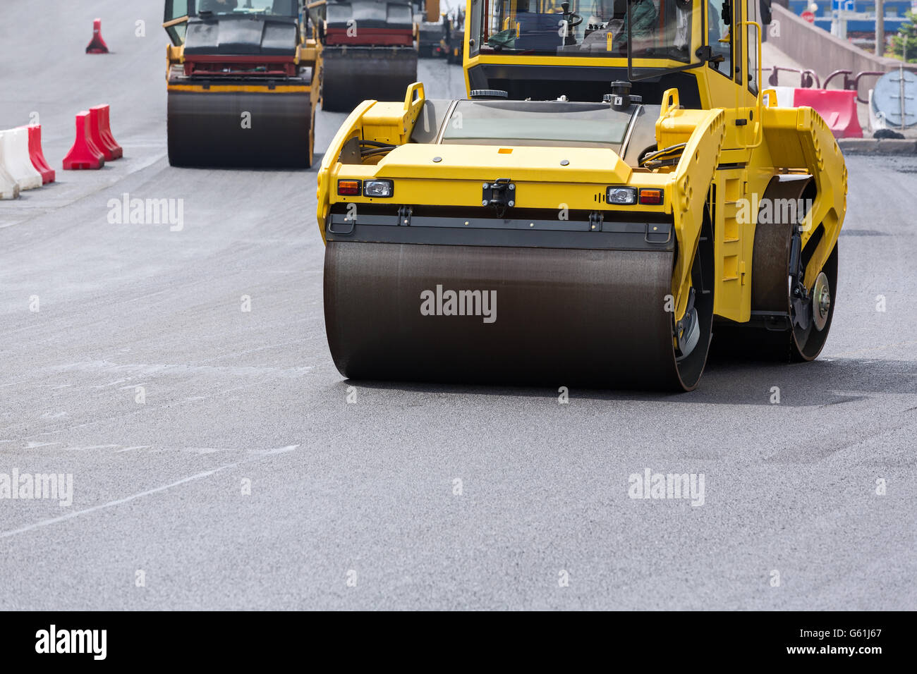Compactor roller during asphalting works at road construction Stock