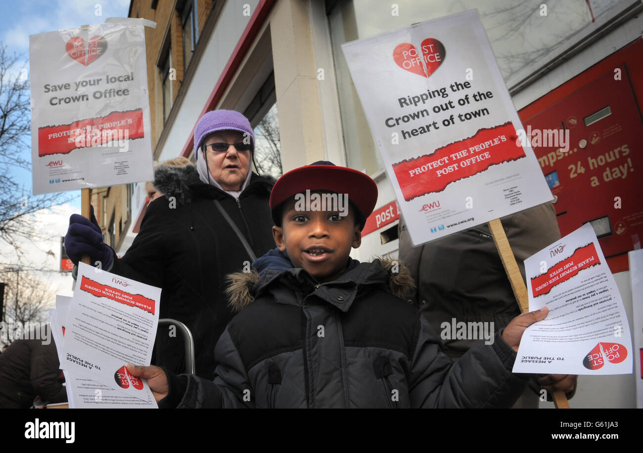 Five year old Josiah Barnes protests with Post Office workers outside