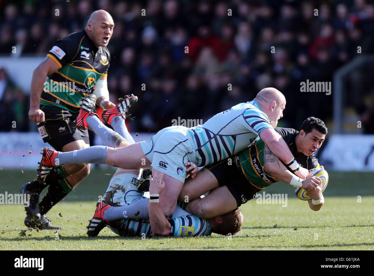 Northampton's George Pisi is tackled by Leicester's Dan Cole during the ...