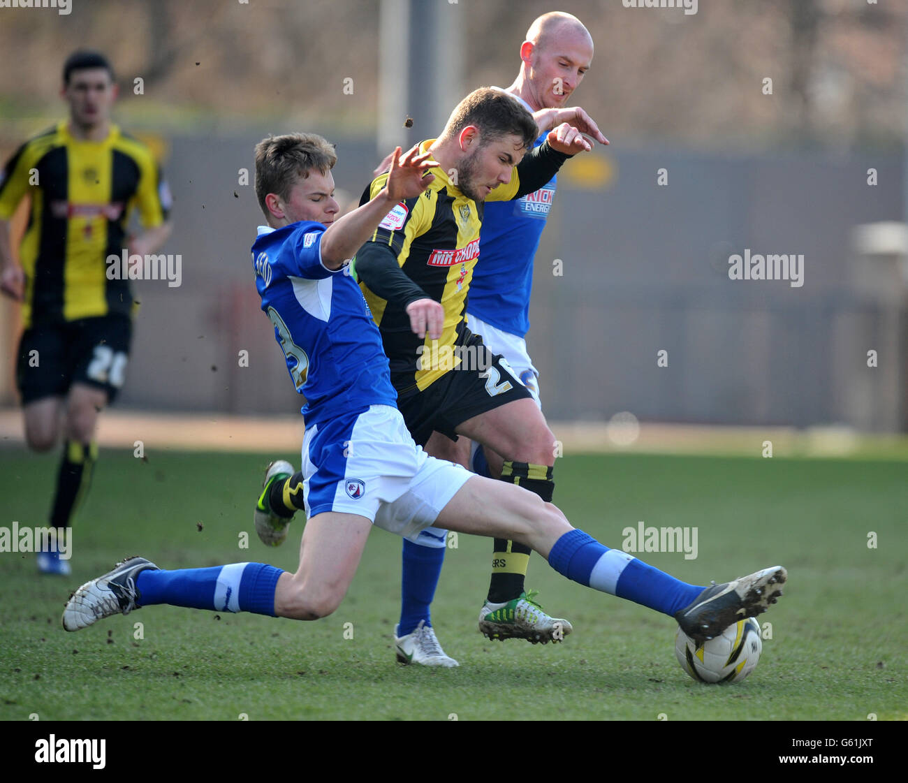 Chesterfield's Conor Townsend (foreground) and Drew Talbot tackle Burton's Alex MacDonald during the npower League Two match at the Pirelli Stadium, Burton. Stock Photo
