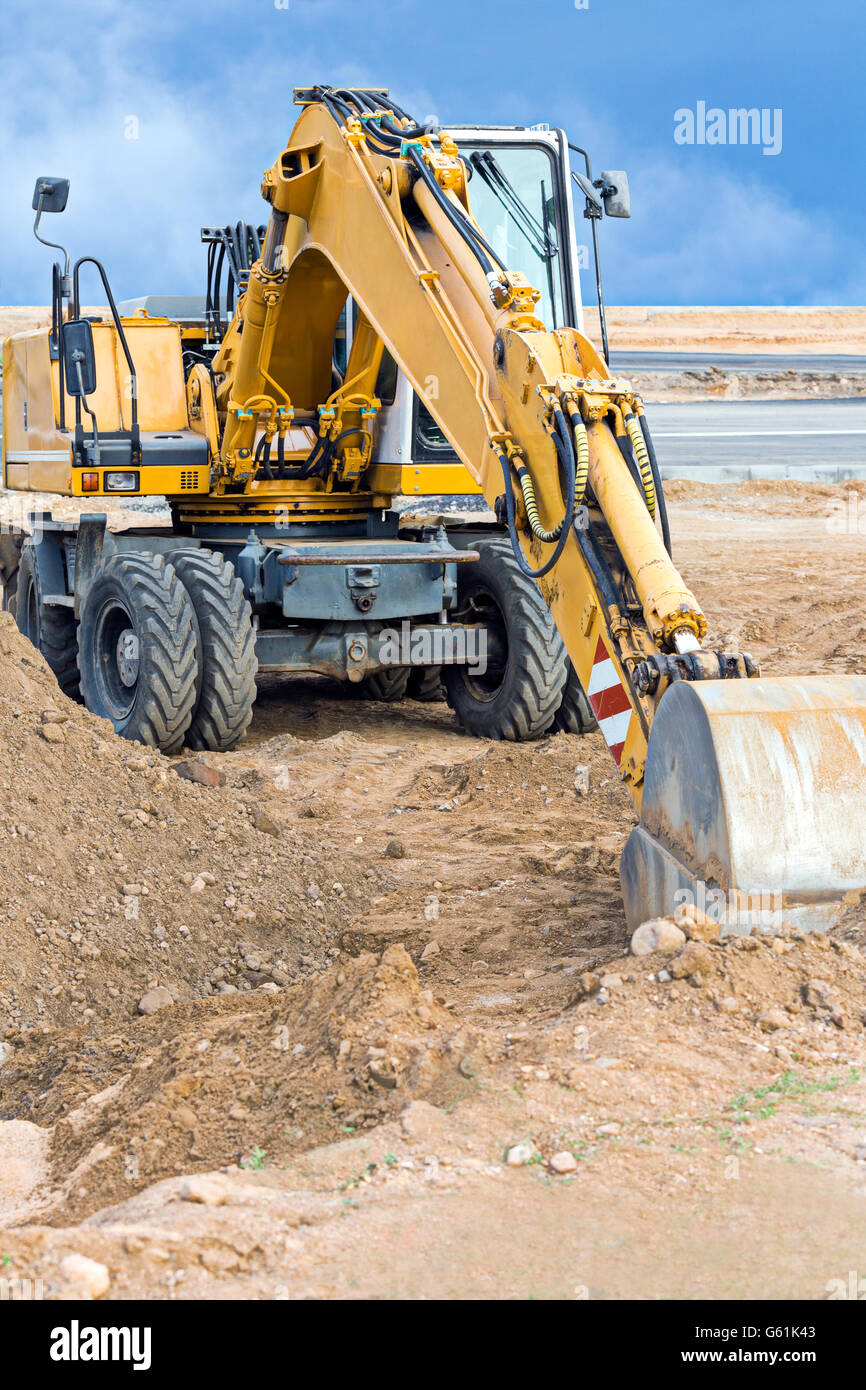 Wheel loader excavator parked at construction site Stock Photo Alamy