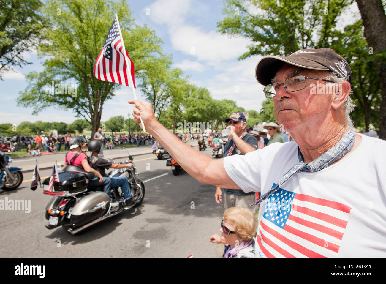 Washington, DC USA, May 29th, 2016: Supporters waving flags during Memorial Day Weekend Rolling Thunder Ride Stock Photo
