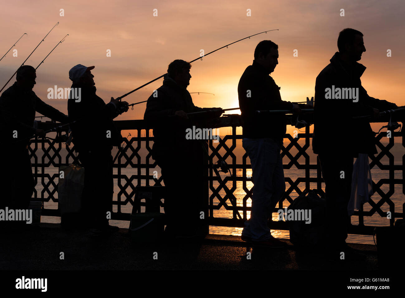 Fishermen in silhouette in Istanbul, Turkey Stock Photo
