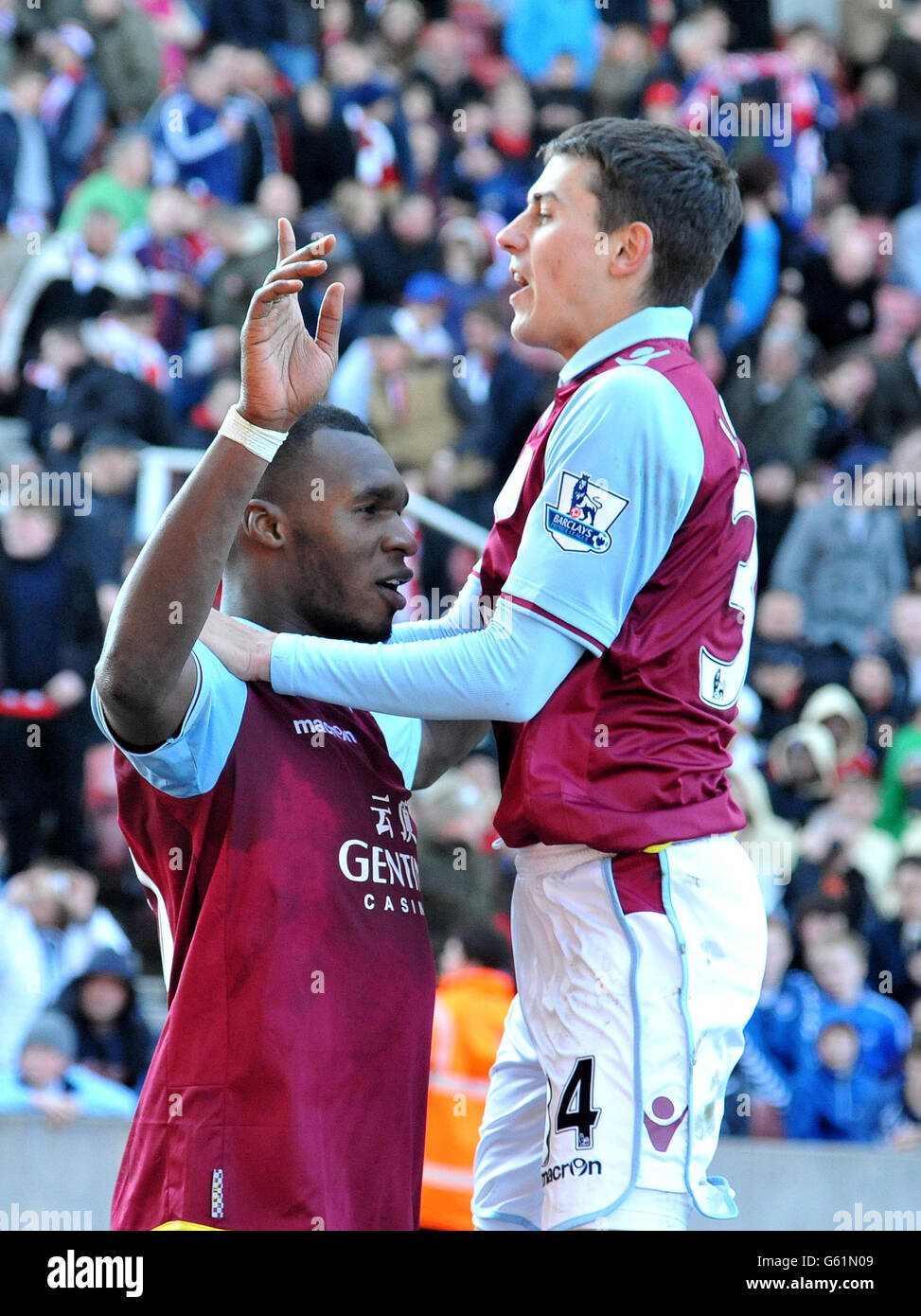 Aston Villa's Christian Benteke (left) is congratulated by Mattew Lowton after scoring their third goal during the Barclays Premier League match at the Britannia Stadium, Stoke on Trent. Stock Photo