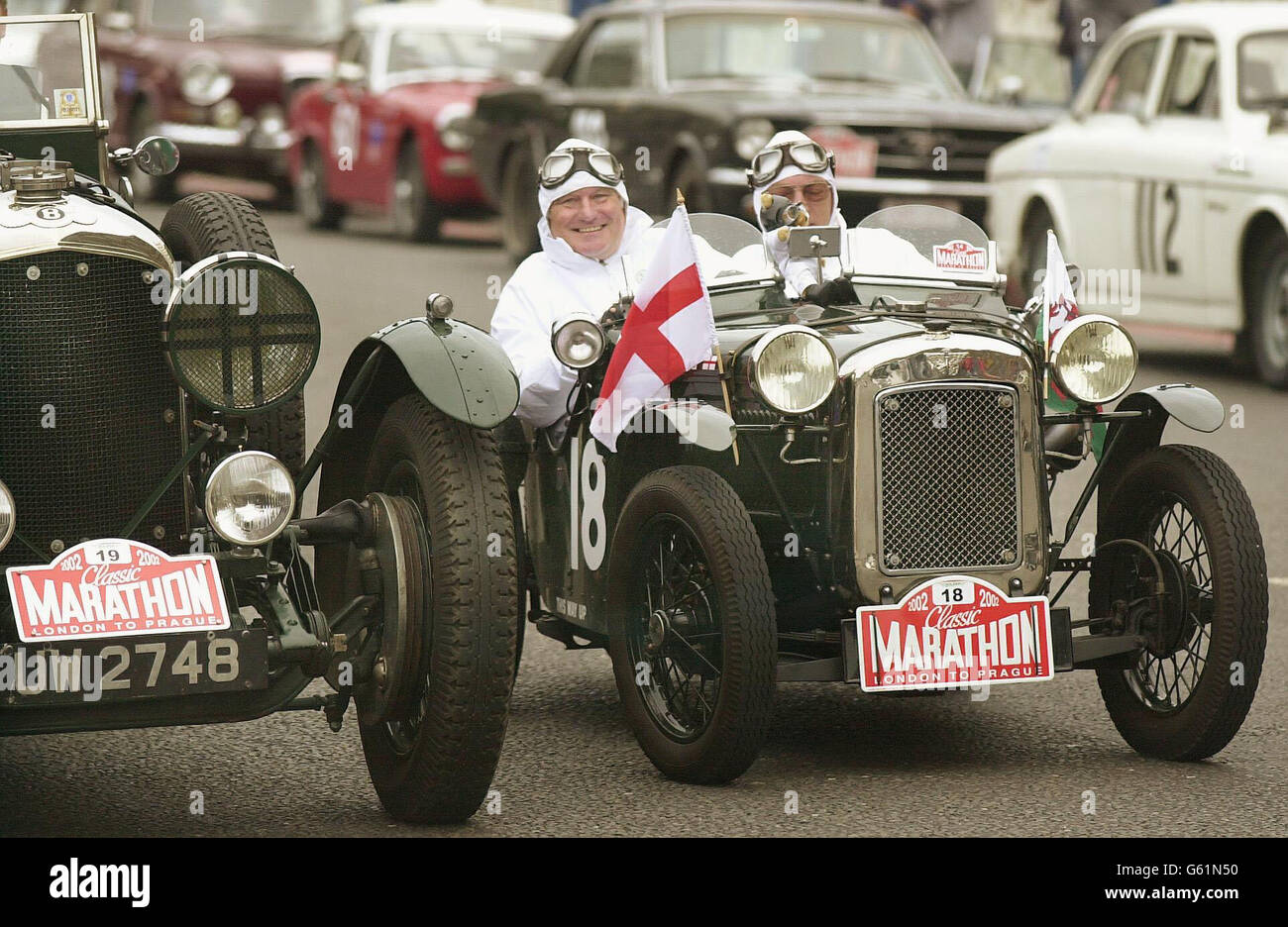 Robert Gourd (left), in his Austin Seven, heads off with the vintageant section of the 14th Classic Car Marathon, from London's Tower Bridge. Europe's biggest rally for classic cars travels through the low-countries and central Europe to end up in flood-ravaged Prague. Stock Photo