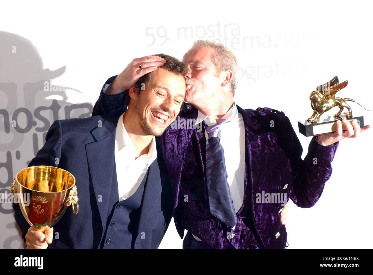 Scottish director Peter Mullan (right) holds the Golden Lion award whilst kissing Italian Actor Stefano Accorsi with his Best Actor award for the movie 'Un viaggio chiamatto amore', during the closing ceremony of the 59th Venice film festival, Venice, Lido, Italy. *....Mullan won the Golden Lion award for his film 'The Magdalene Sisters'. Stock Photo