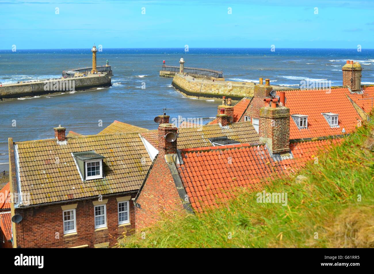 A view of Whitby Pier and harbour looking across rooftops in The North ...