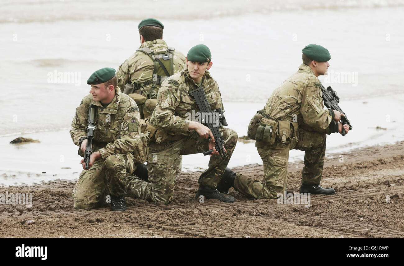 A member of the Armoured Support Group Royal Marines prepares ahead of exercise Joint Warrior, that will involve more than 40 warships, 30 fixed wing aircraft and 30 helicopters on Barry Buddon beach in Scotland. Stock Photo