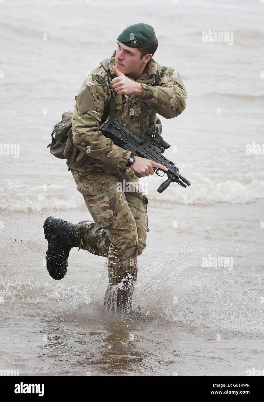 A member of the Armoured Support Group Royal Marines prepares ahead of exercise Joint Warrior, that will involve more than 40 warships, 30 fixed wing aircraft and 30 helicopters on Barry Buddon beach in Scotland. Stock Photo
