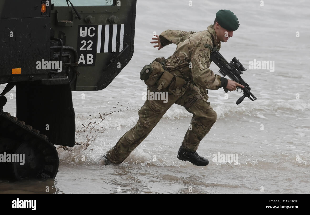 A member of the Armoured Support Group Royal Marines prepares ahead of exercise Joint Warrior, that will involve more than 40 warships, 30 fixed wing aircraft and 30 helicopters on Barry Buddon beach in Scotland. Stock Photo