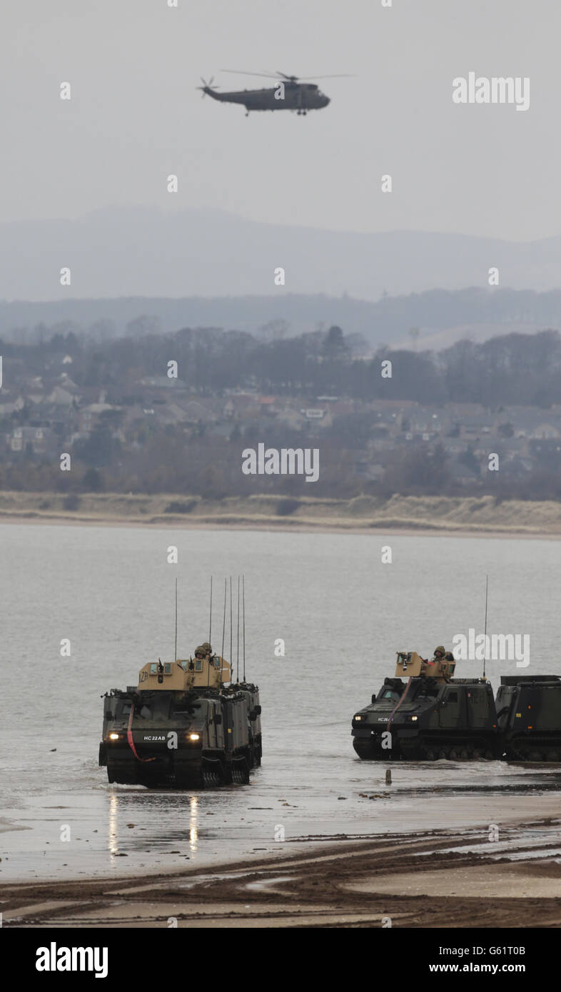 Members of the Armoured Support Group Royal Marines prepare ahead of exercise Joint Warrior, that will involve more than 40 warships, 30 fixed wing aircraft and 30 helicopters on Barry Buddon beach in Scotland. Stock Photo