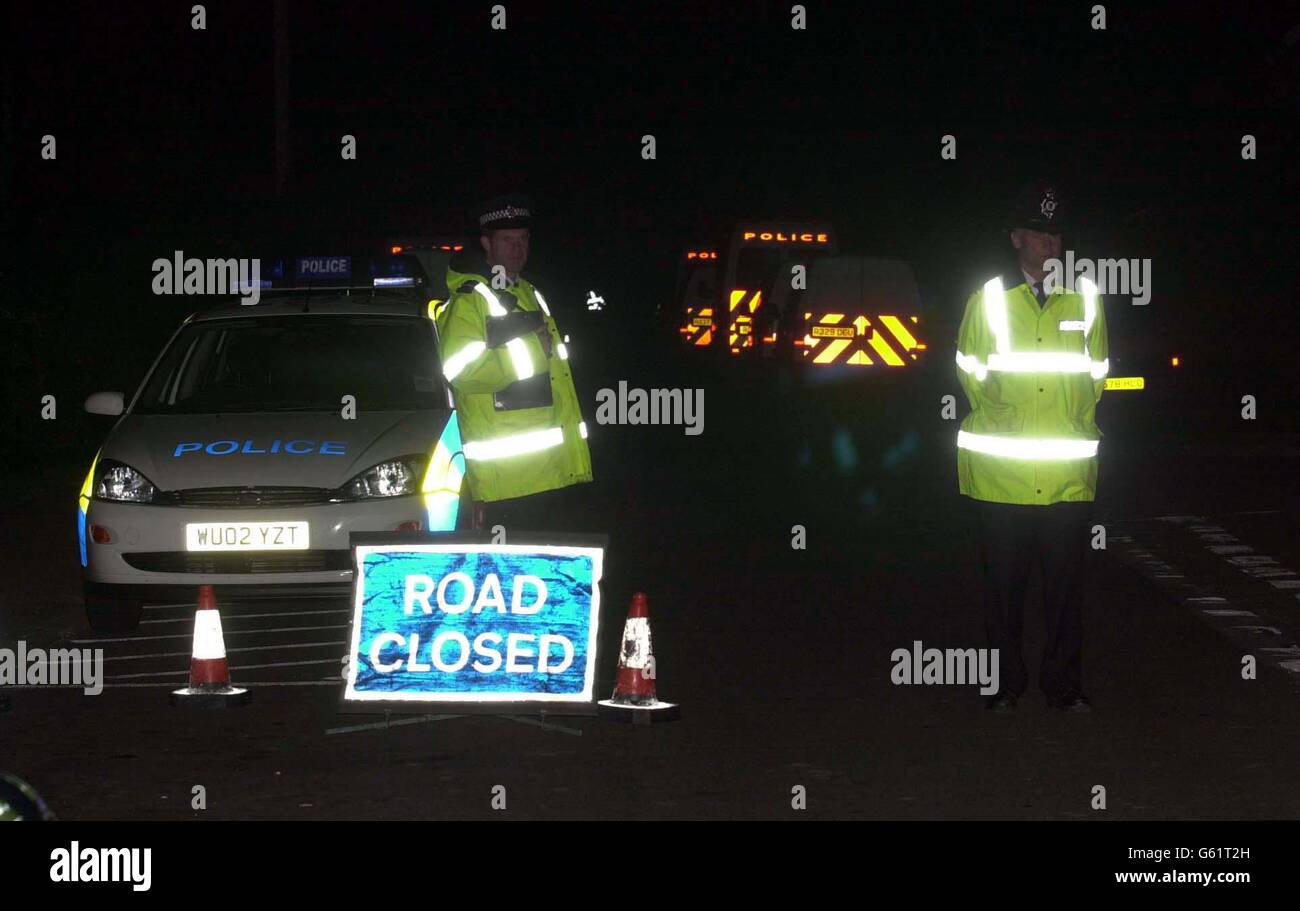 Police guarding the scene this evening in Goose Lane, Horton, near Ilminster, Somerset. Where three people were killed in a suspected shooting. * The body of a woman was found in a parked car, the body of a young girl was nearby and the body of a man was found in the back garden of a nearby house, Avon and Somerset Police said. Stock Photo