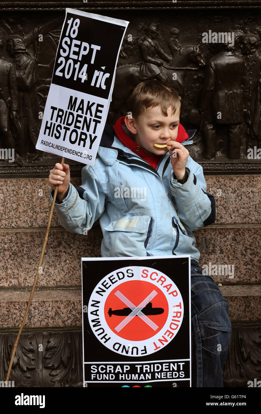 A young child makes his point on streets of Glasgow for a Scrap Trident demonstration. MSPs and trade unionists join campaigners to protest against the planned renewal of Trident nuclear weapons. Stock Photo