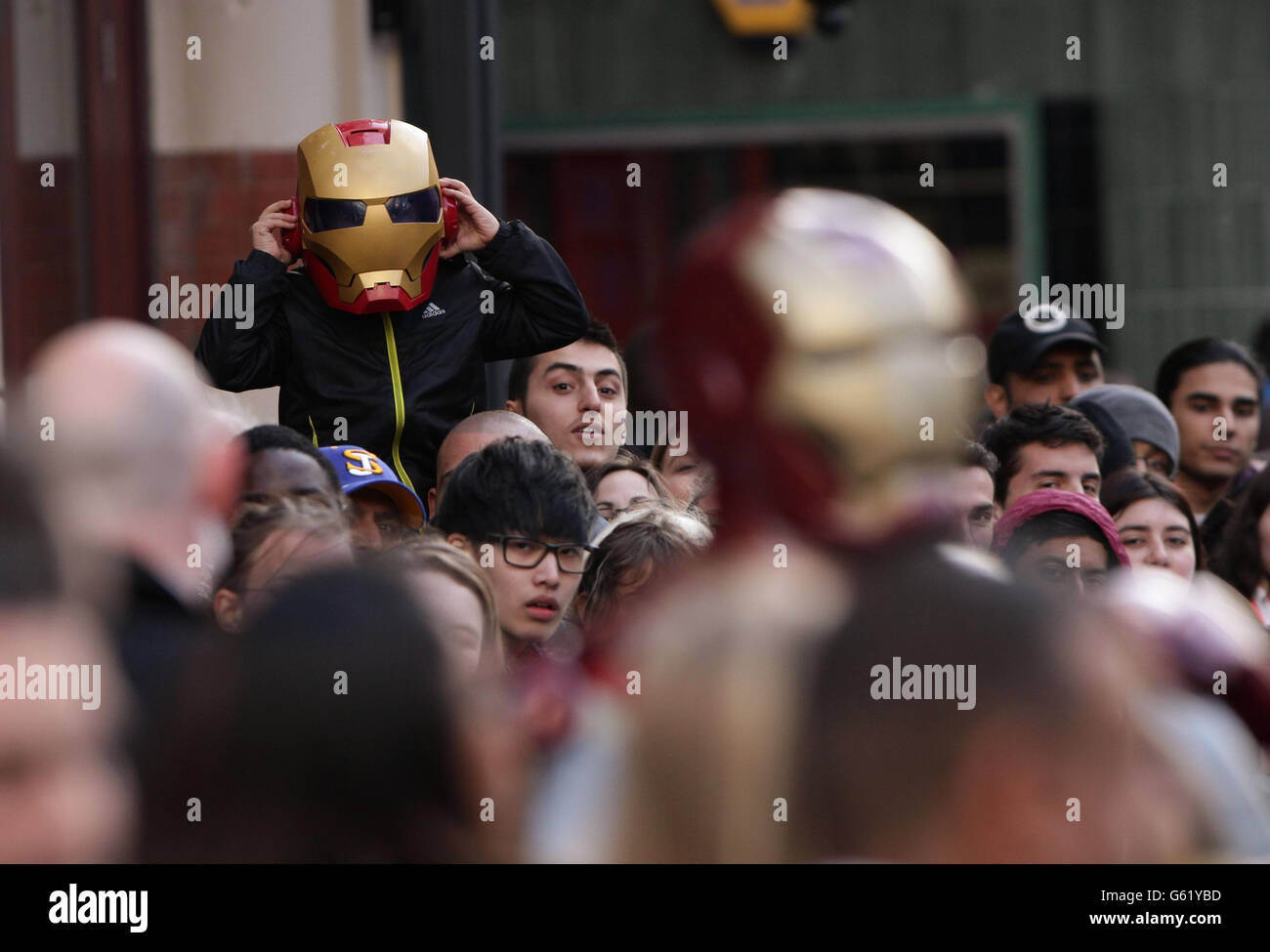 A fan in the crowd wearing an Iron Man mask at the premiere of Iron Man 3 at the Odeon Leicester Square, London. Stock Photo