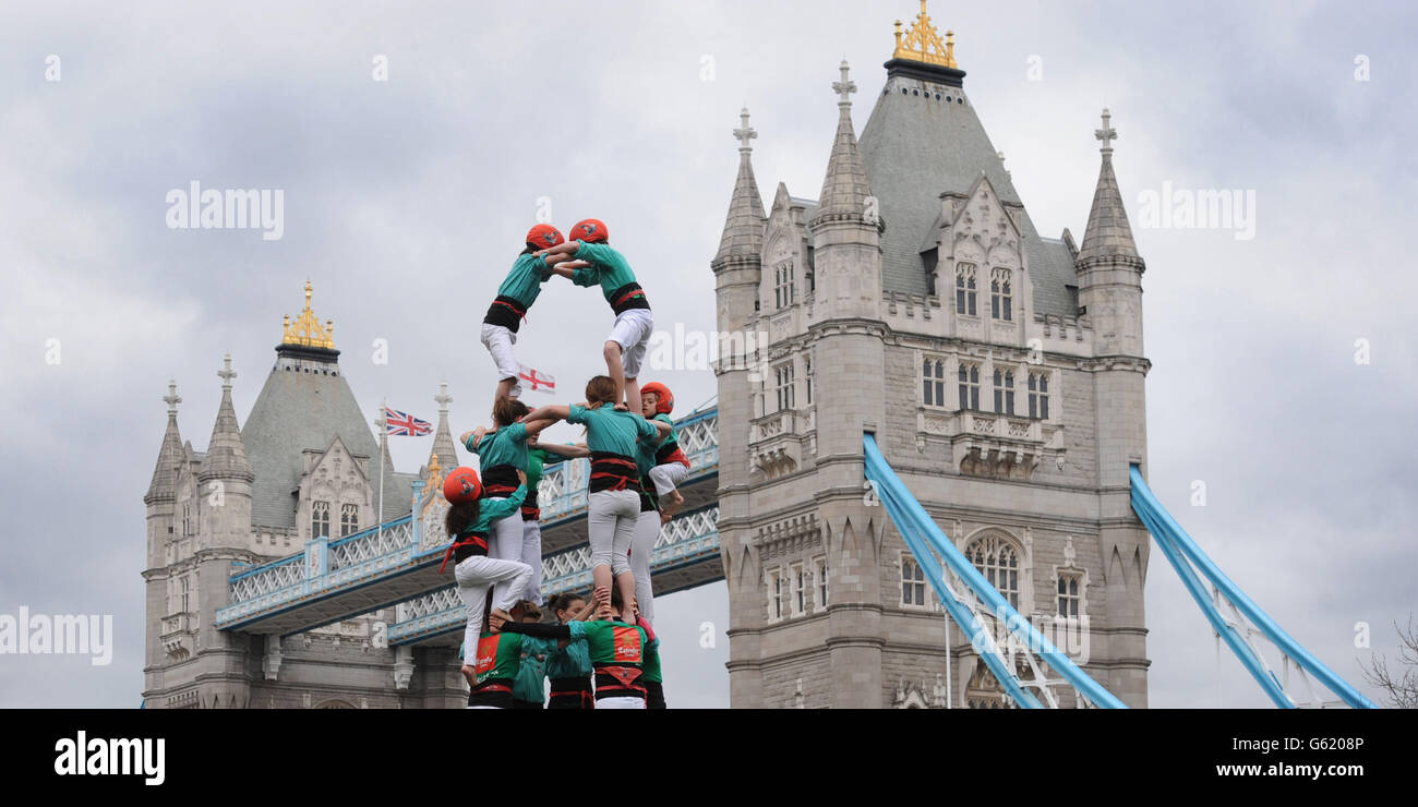 Members of the Human Towers Castellers de Vilafranca team form successively smaller tiers by climbing up the bodies of each layer to mount the shoulders of the previous tier until the tower is complete at Tower Bridge in London. A uniquely Catalan custom, the Human Towers have been constructed during town celebrations and festivals in Barcelona for three hundred years and are described by UNESCO as an Intangible Cultural Heritage of Humanity. Stock Photo