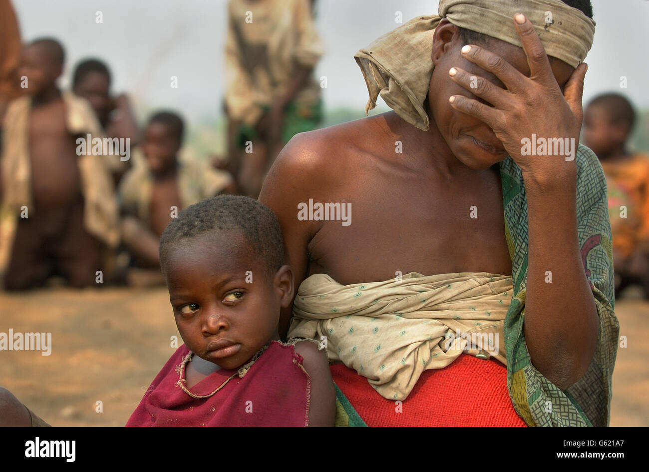 Magetsi Nyankalidzi, 30, becomes distraught as she recounts searching for water-lily bulbs to eat in the Elephant Marshes off the Shire river in southern Malawi, as her daughter Mavudo, 4, looks on. * The women continue the work despite the risk of crocodile attacks, which have led to numerous deaths, as it is one of the few sources of food remaining. The United Nations currently estimates 18.4 million people face starvation in the southern Africa region. Stock Photo