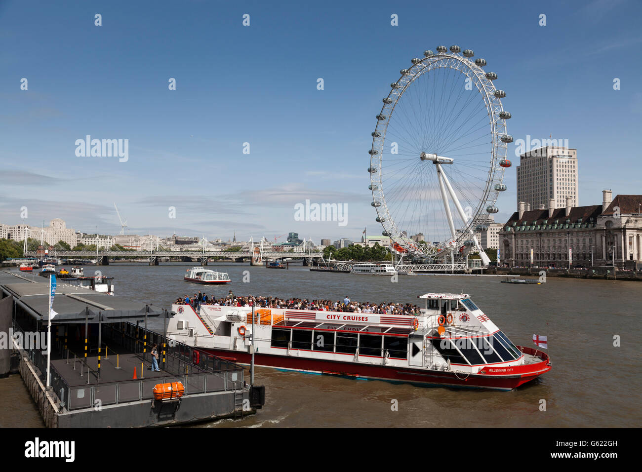 London Eye and a river cruiser on the River Thames, London, England, United Kingdom, Europe Stock Photo
