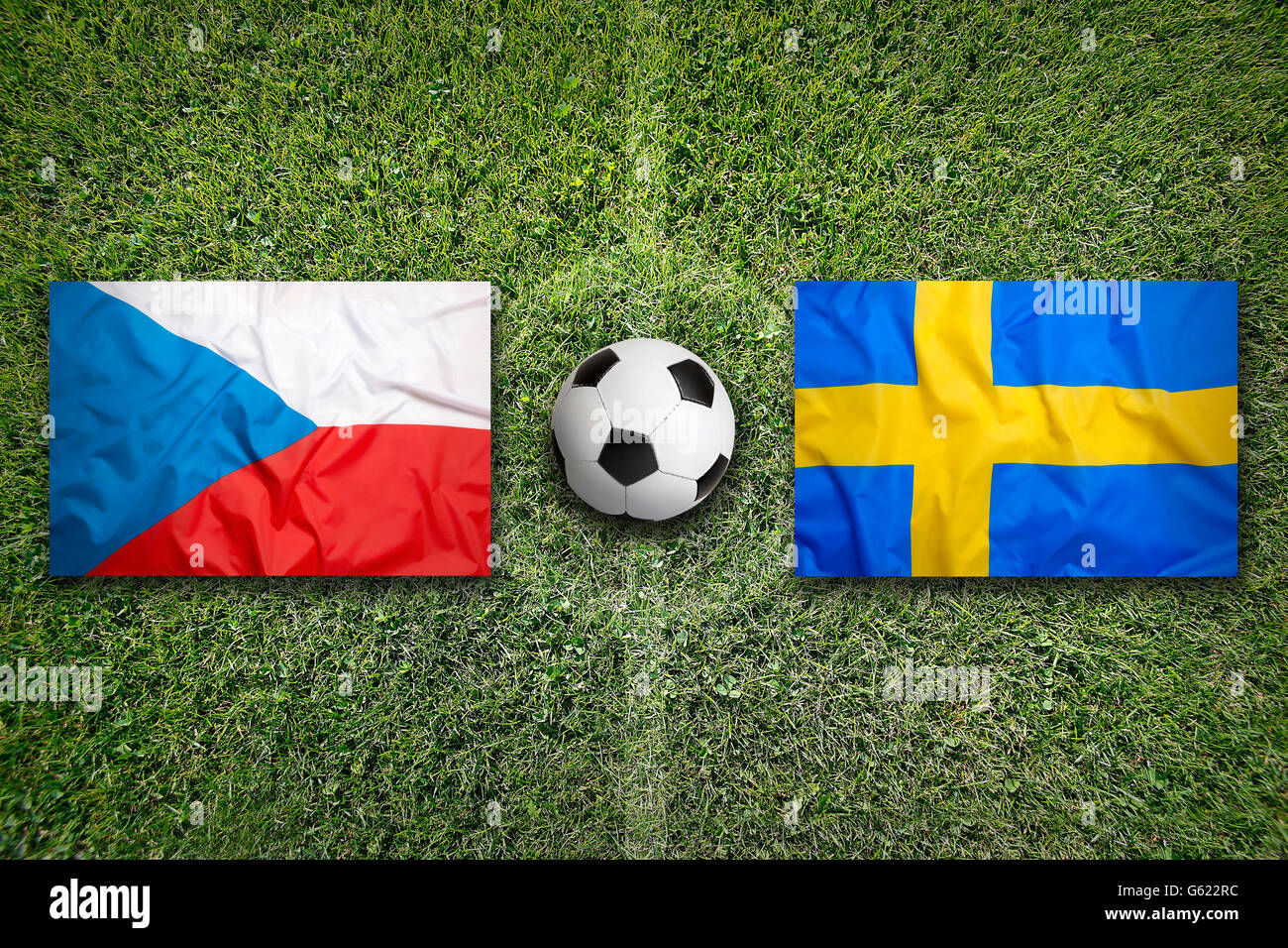 Czech Republic vs. Sweden flags on green soccer field Stock Photo