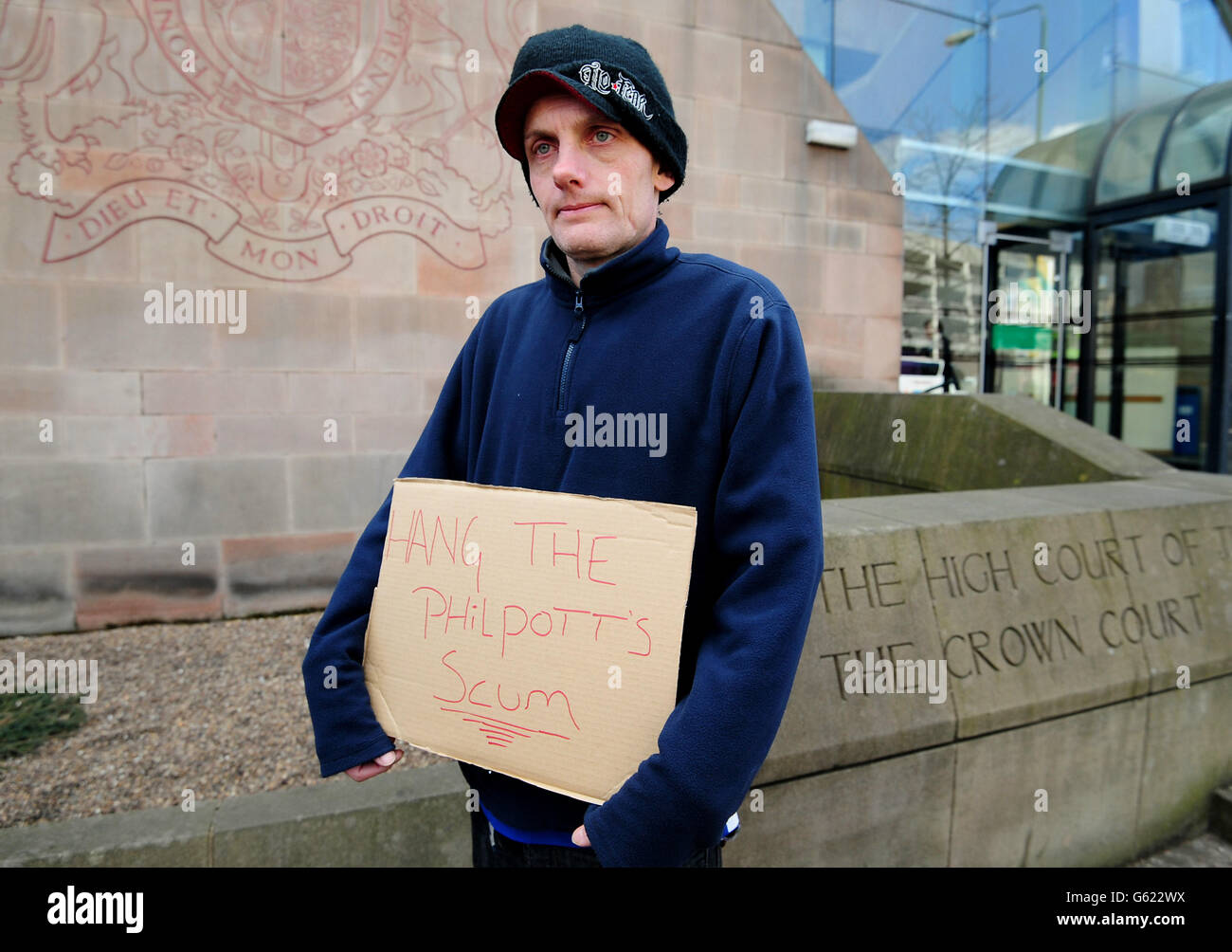 Russell Wells from Nottingham holds a sign outside Nottingham Crown Court, where Mick Philpott and his wife Mairead are waiting to be sentenced after they were convicted of six separate counts of manslaughter following the deaths of Philpott's six children in the family home in Victory Road, Derby. Stock Photo