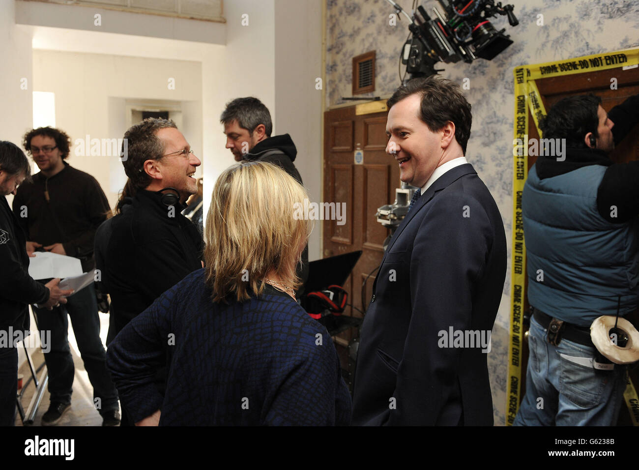 Chancellor George Osborne speaks with director Jeremy Lovering and executive producer Sue Vertue on the set of Sherlock at Hensol Castle, Cardiff. Stock Photo