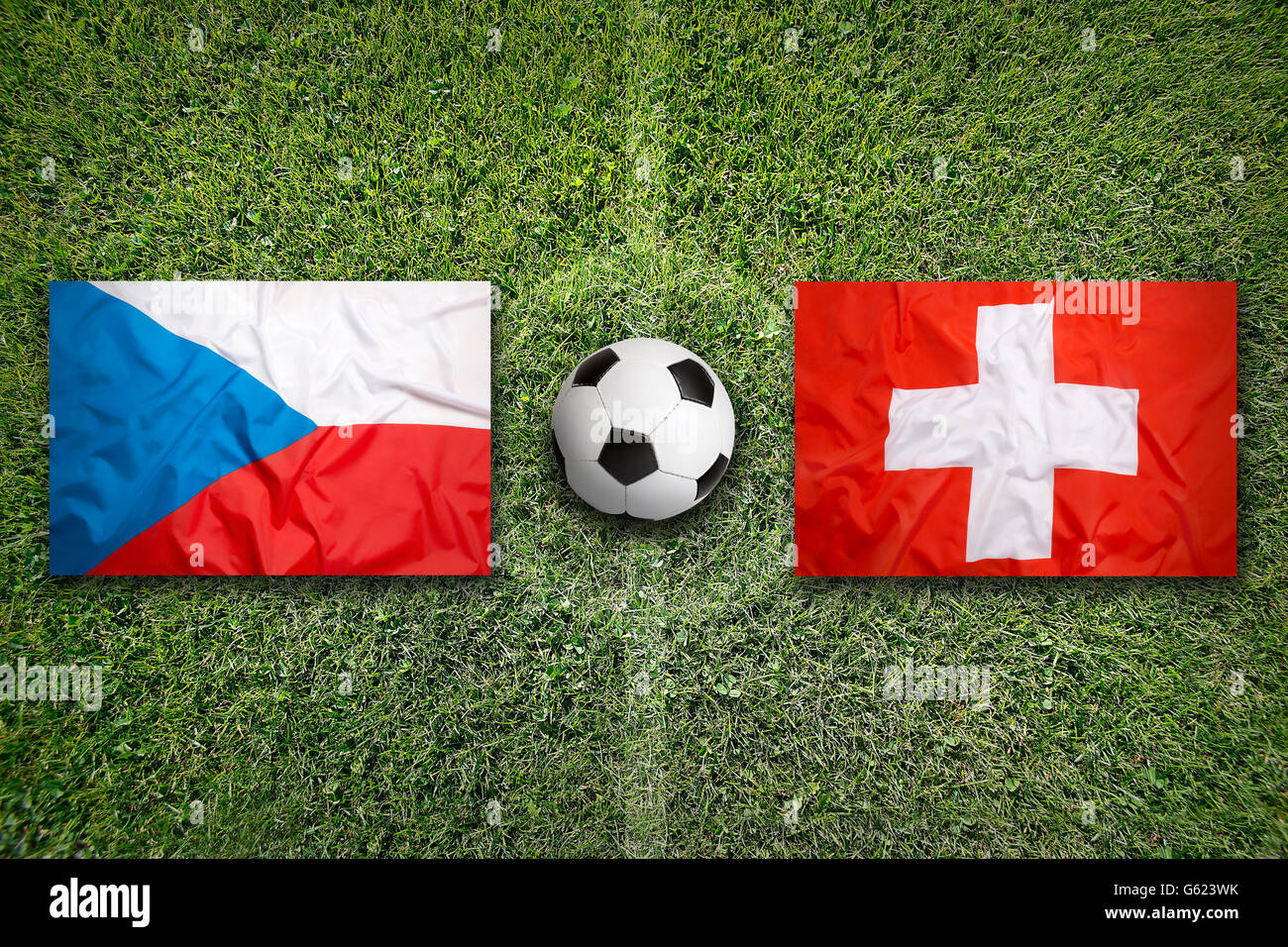 Czech Republic vs. Switzerland flags on green soccer field Stock Photo